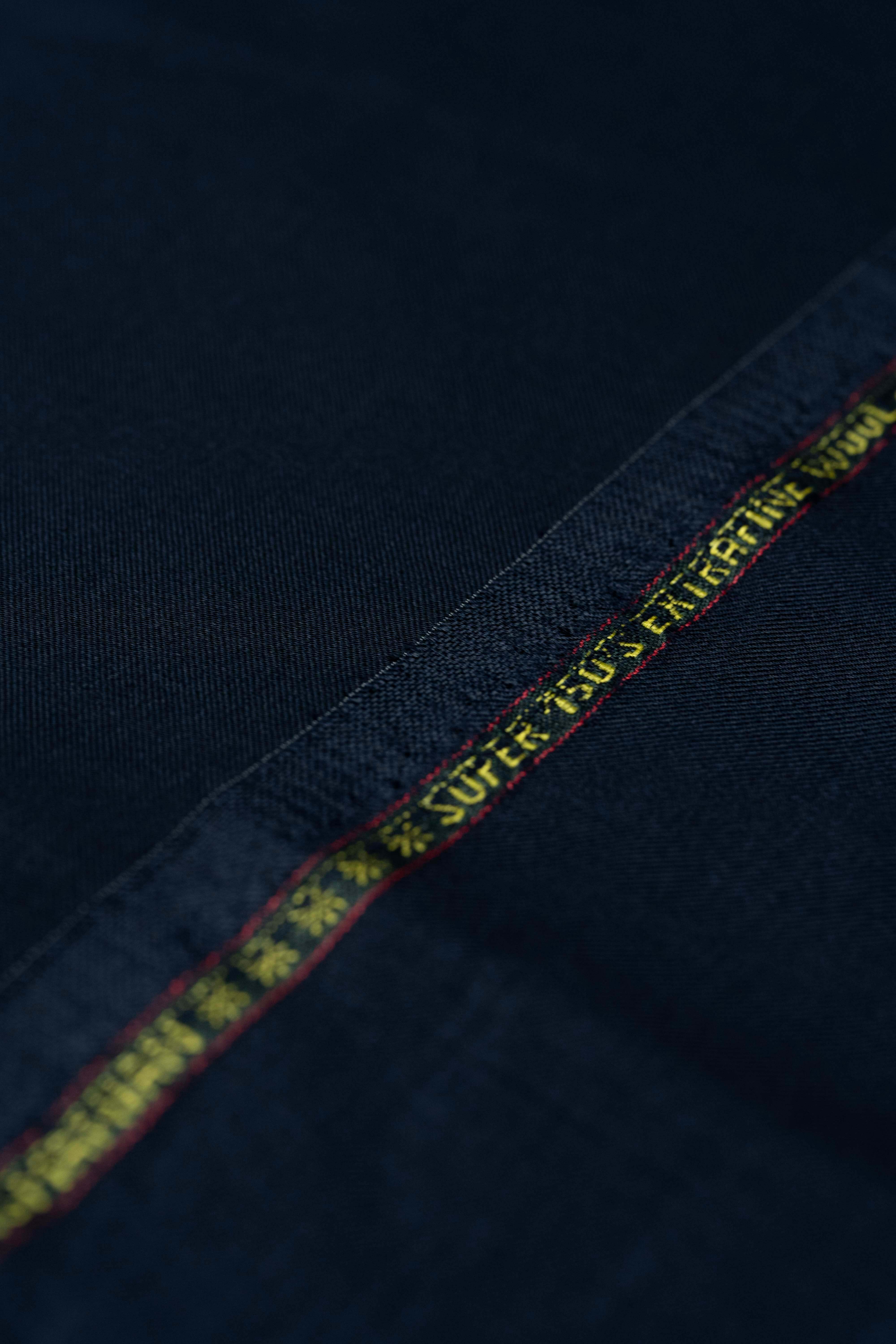 Loro Piana Dark Navy Tasmanian 150's Wool Suit Fabric detailed close-up showing texture and branding.