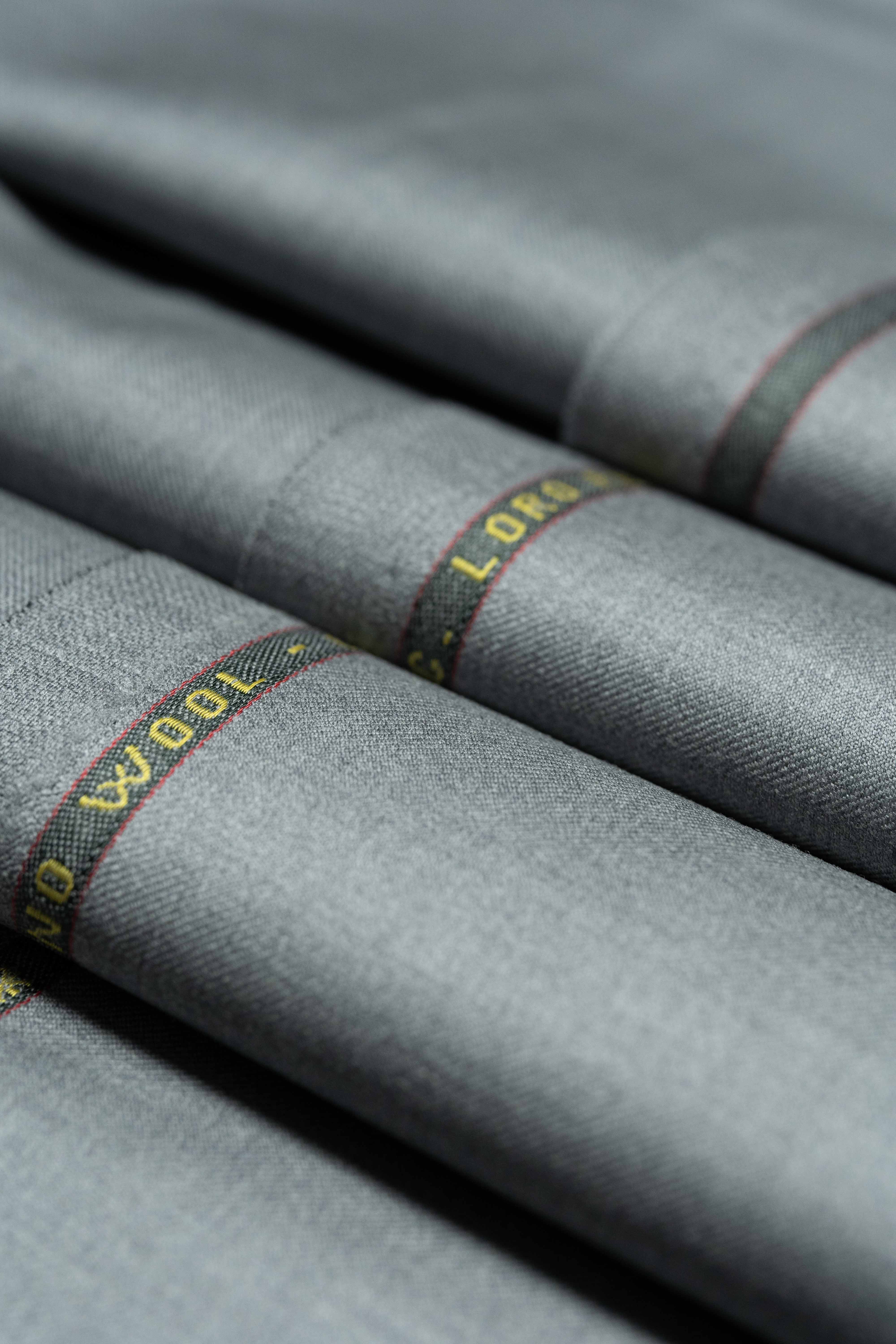 Loro Piana Grey Australis 150's Merino Wool Suit Fabric in luxurious folds, showcasing fine craftsmanship.
