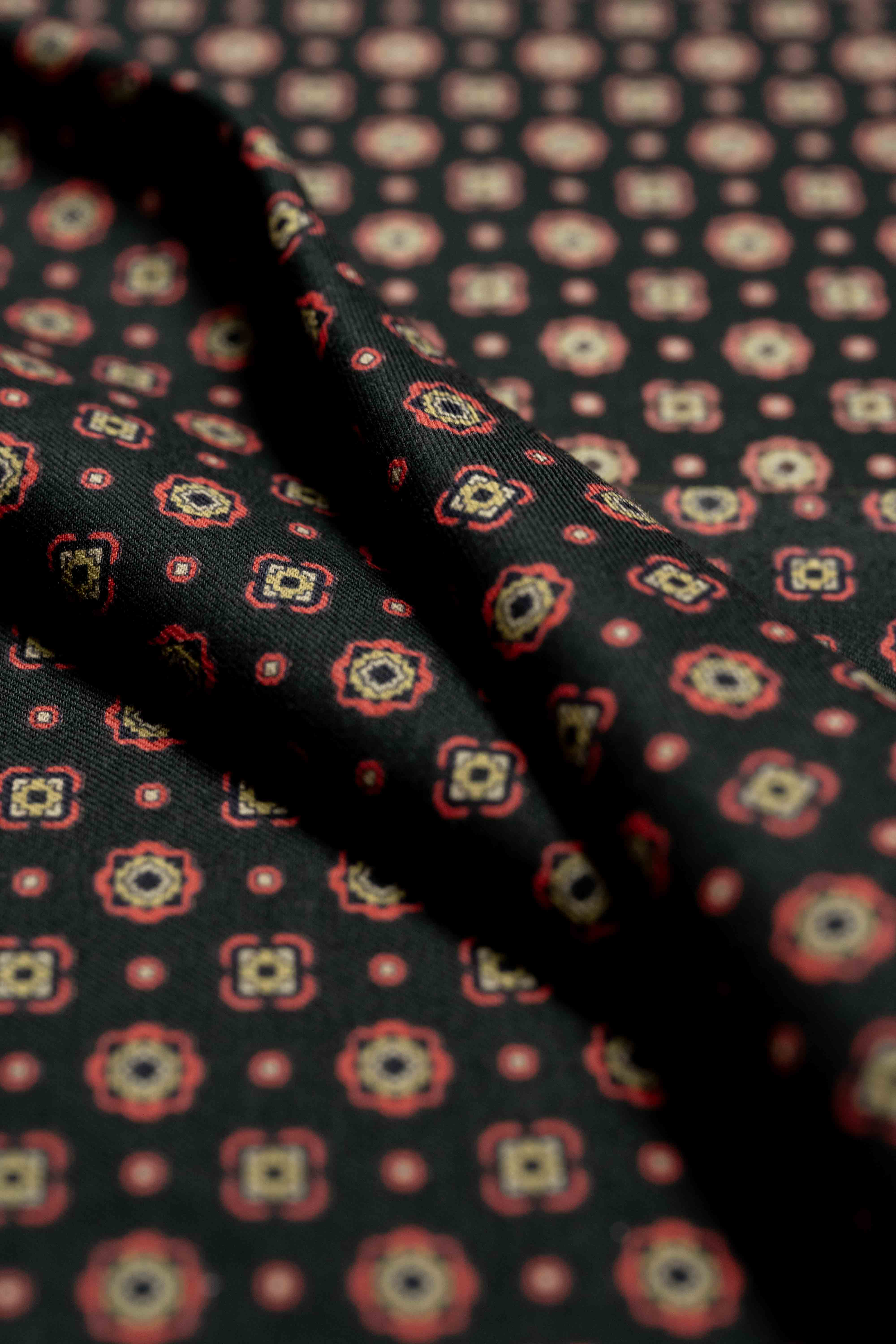 Close-up of vintage fabrics in wool and cotton featuring a patterned design, perfect for shirts and ties.
