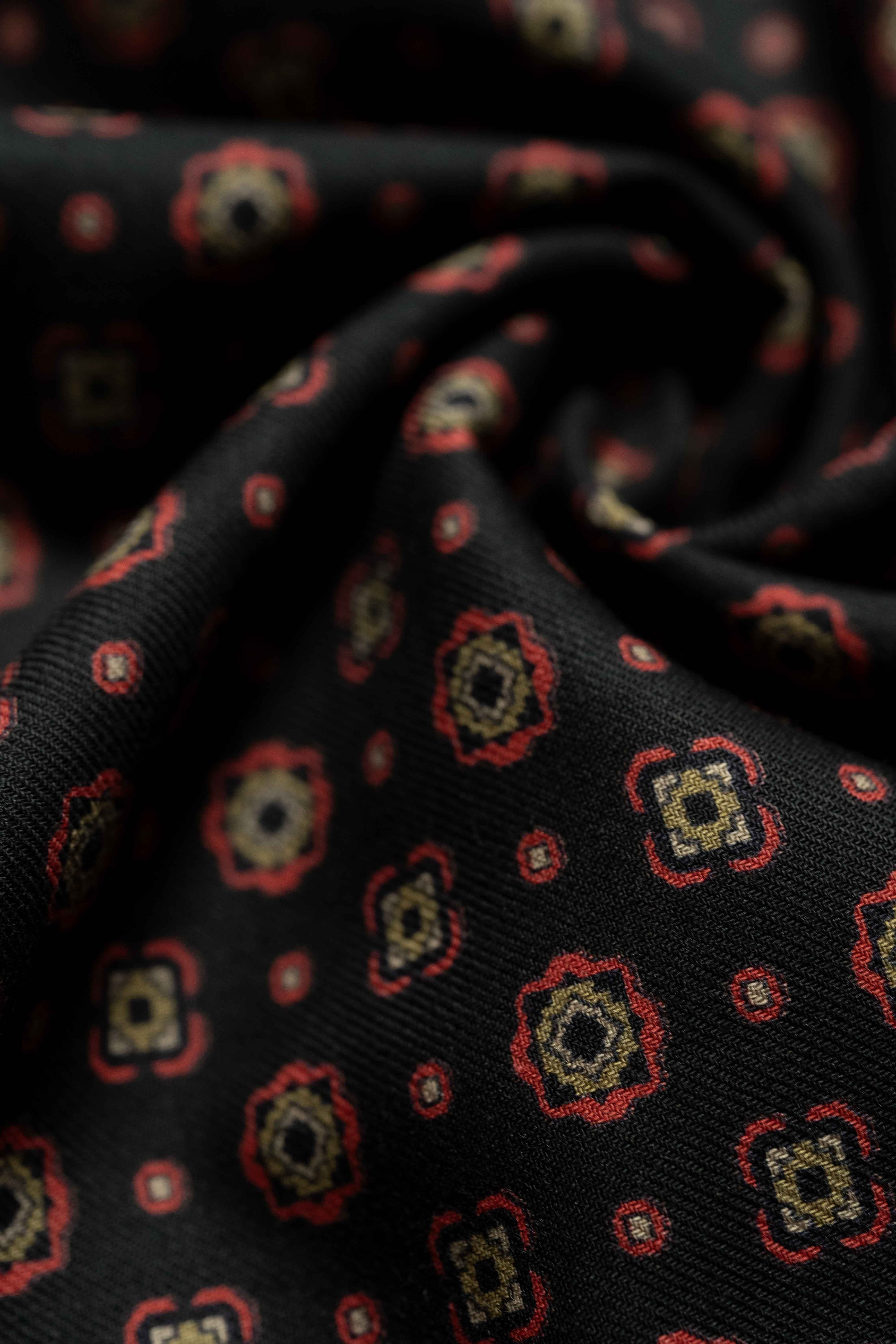 Vintage fabrics featuring intricate floral patterns in red and gold on a black background, perfect for shirts and ties.