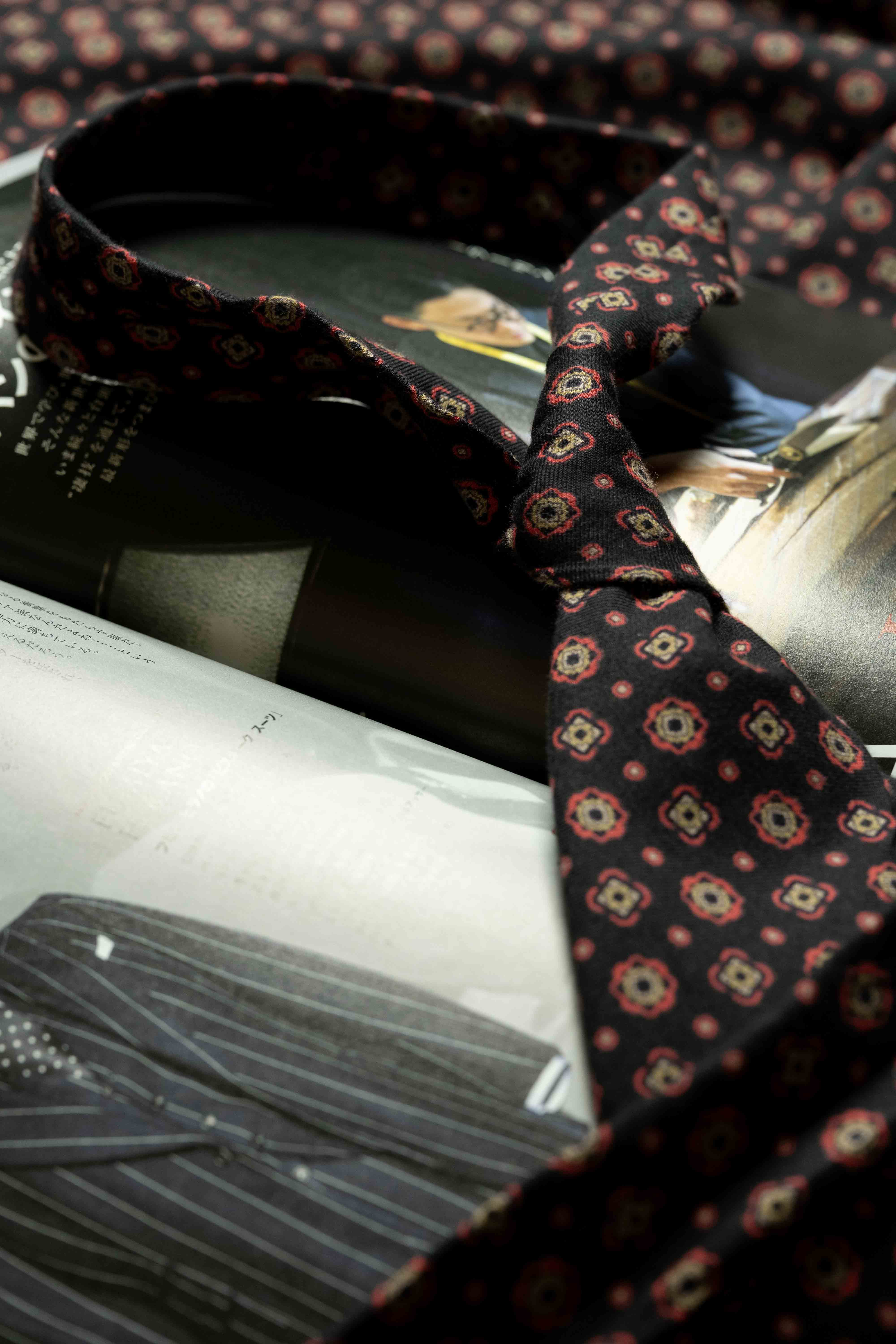 Vintage fabrics wool and cotton tie displayed on fashion magazines, perfect for stylish shirts and accessories.