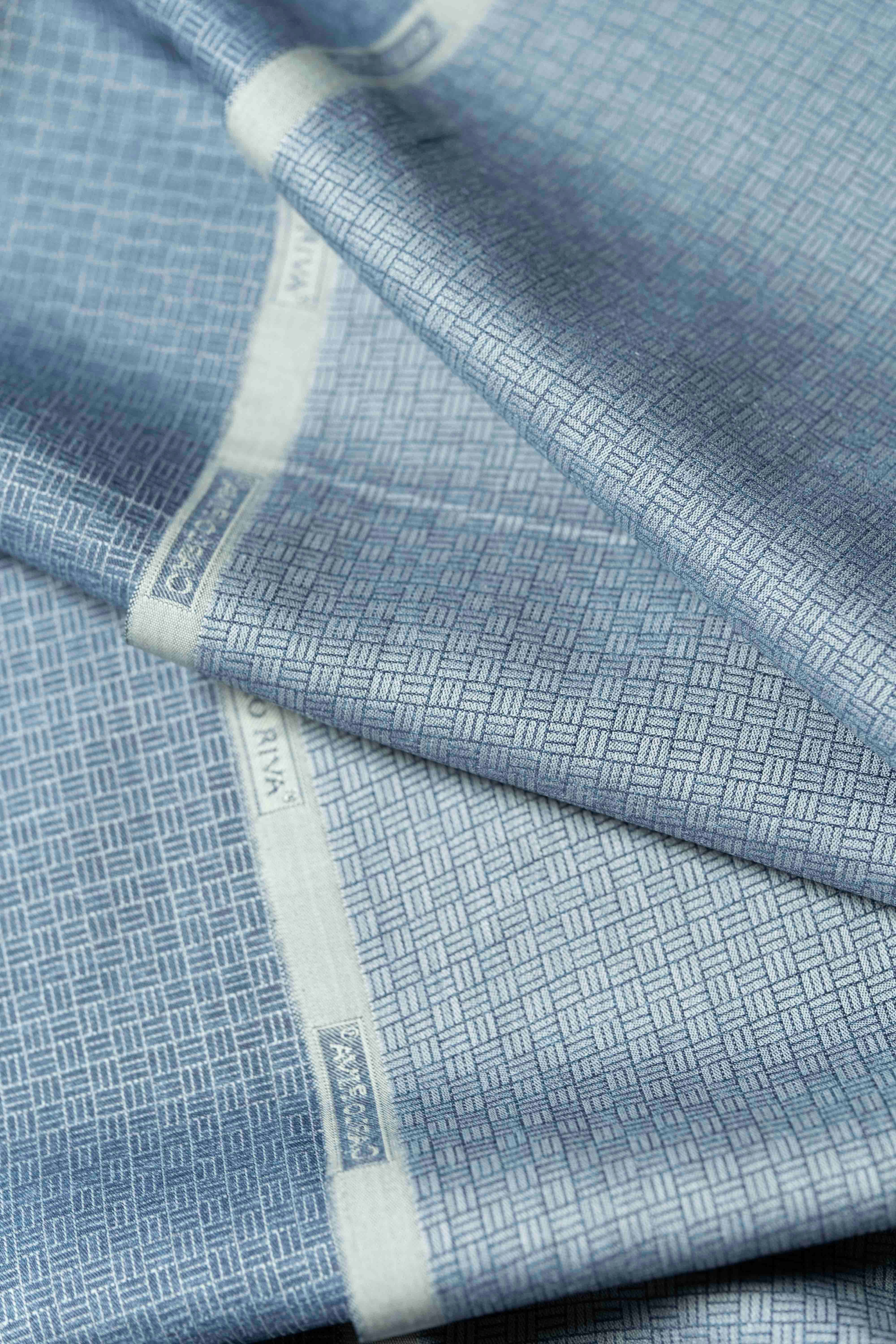 Close-up of Carlo Riva navy geometric shirt fabric showcasing intricate patterns and smooth texture.