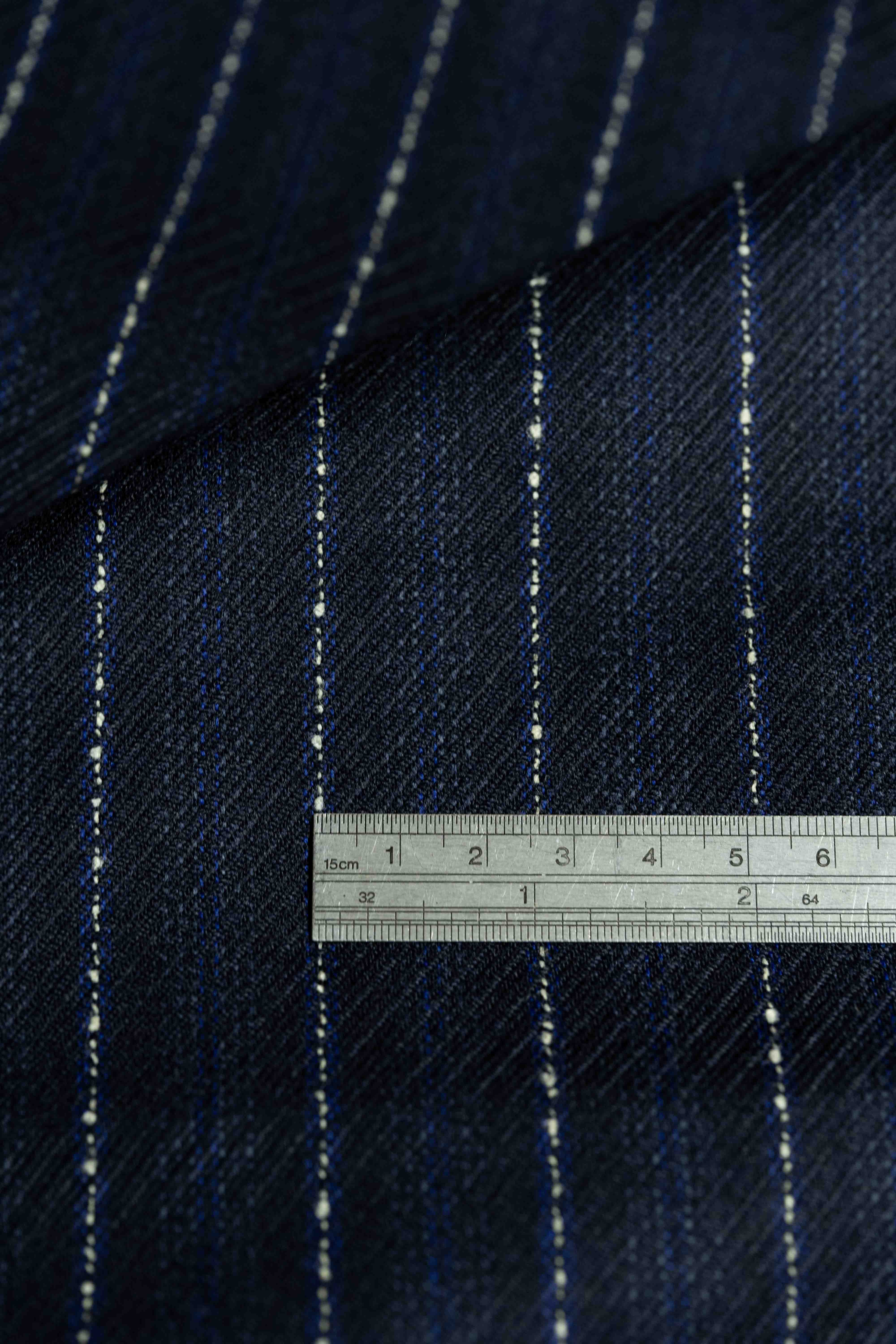 Dormeuil Blue & White Stripe Wool Suiting fabric with ruler for scale, showcasing fine details and texture.