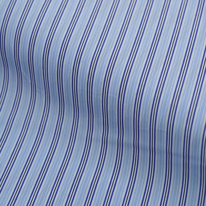 Canclini striped fabric in light blue and navy, showcasing the playful design elements of Italian shirting.