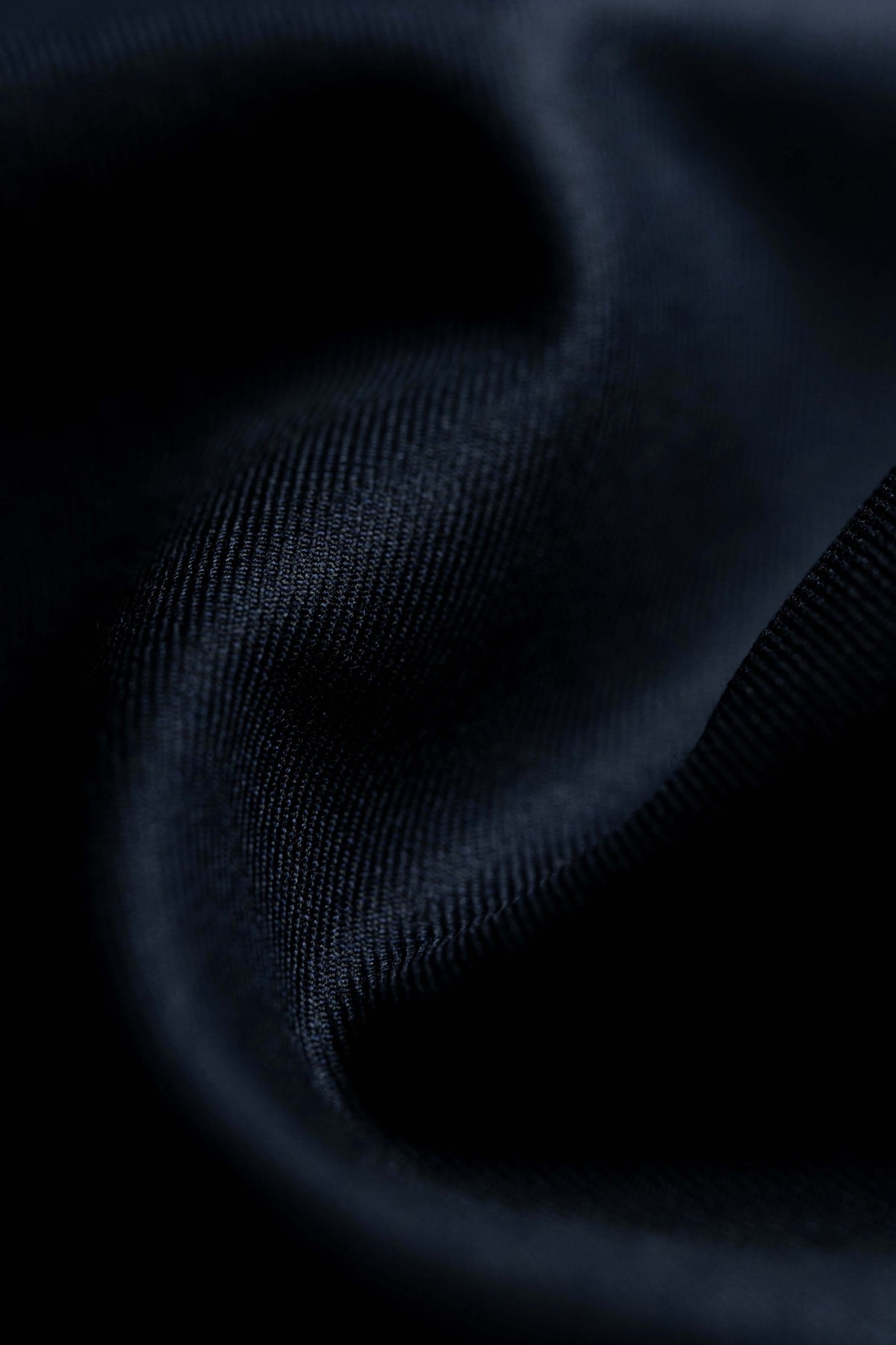 Close-up of luxurious Suit Fabrics showcasing dark texture ideal for tailored suits.