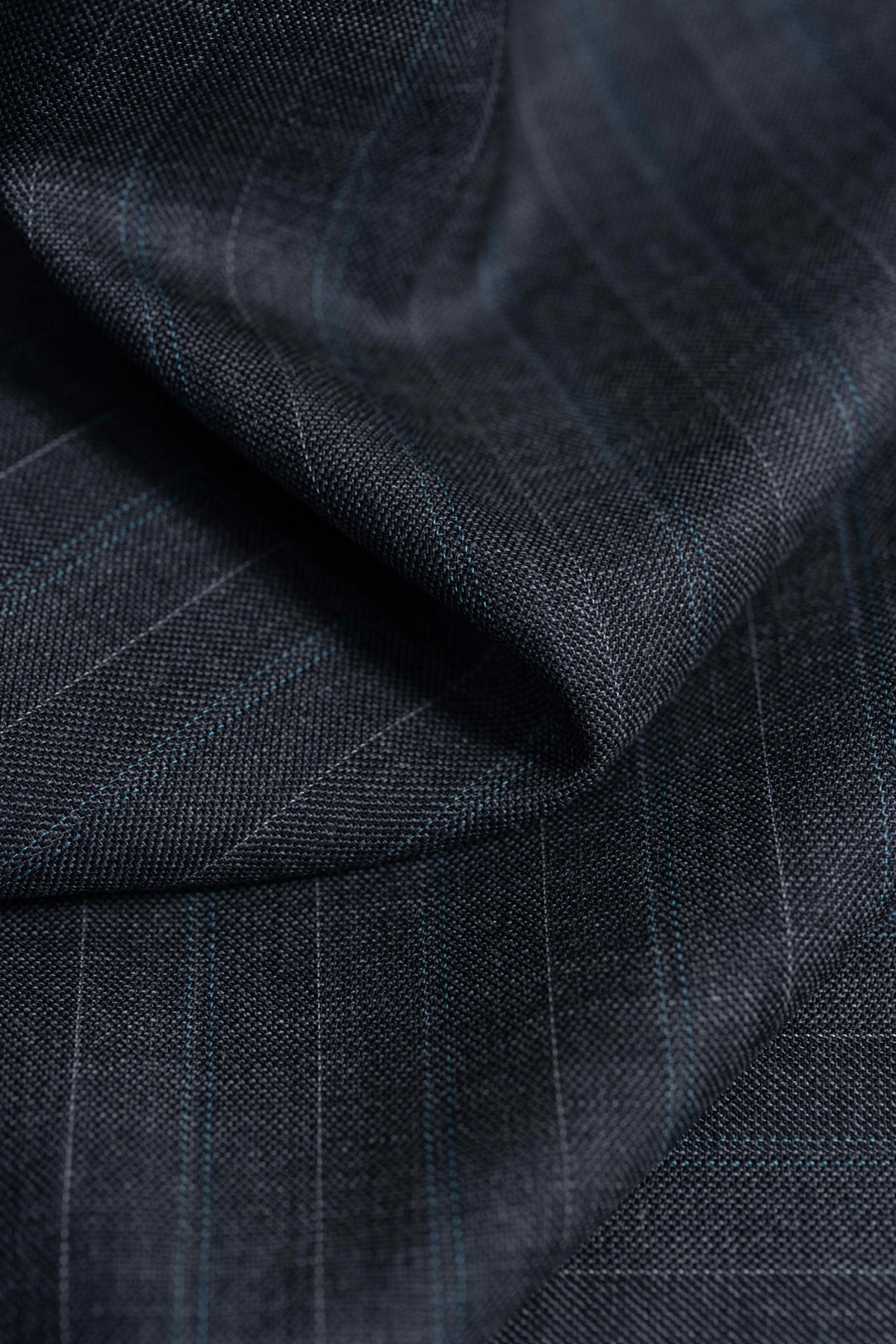 Barrington Panama Weave fabric featuring a charcoal color and subtle blue stripes for suiting.