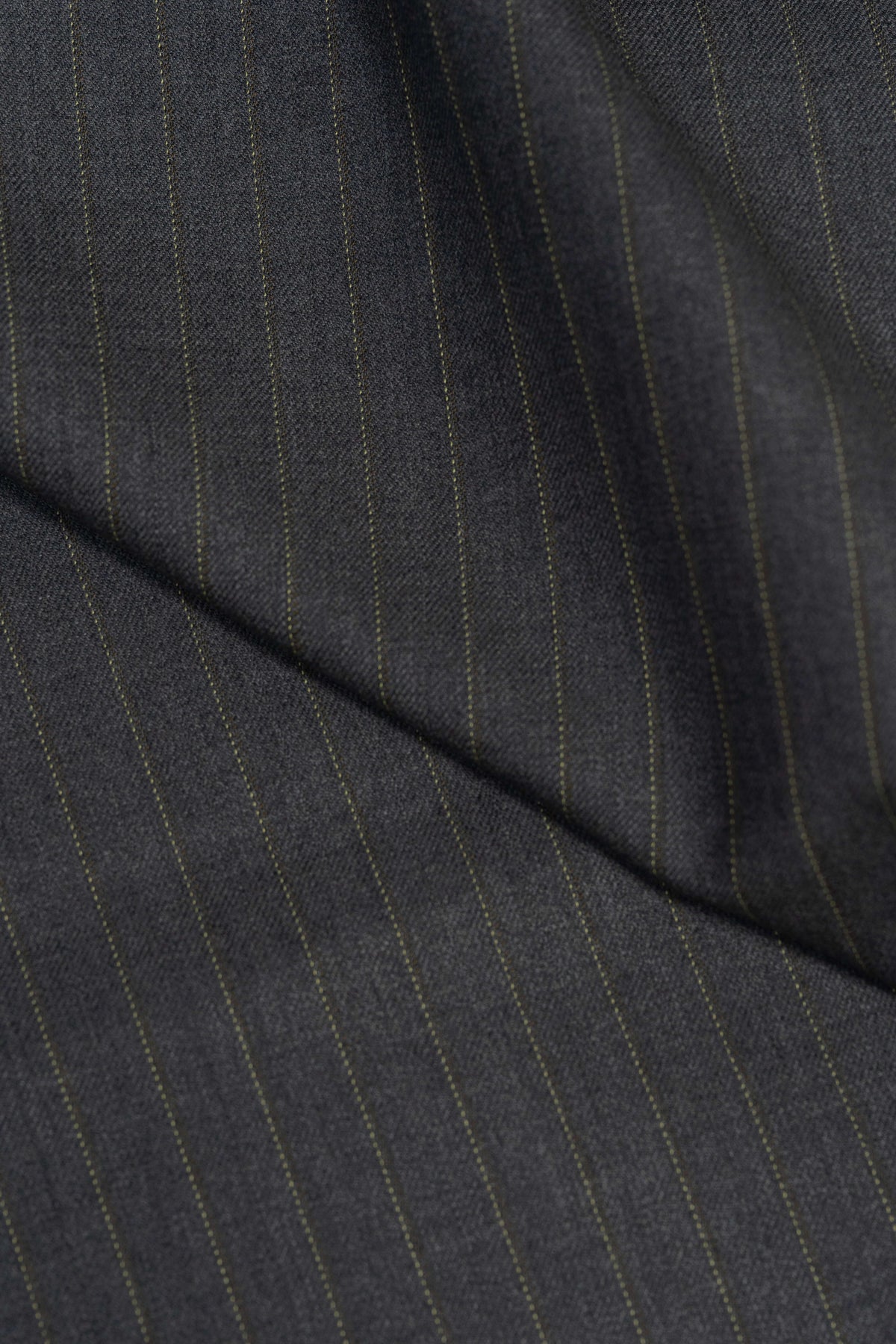 Close-up of Barrington Grey super merino wool suiting fabric with yellow stripe, showcasing its texture and design.