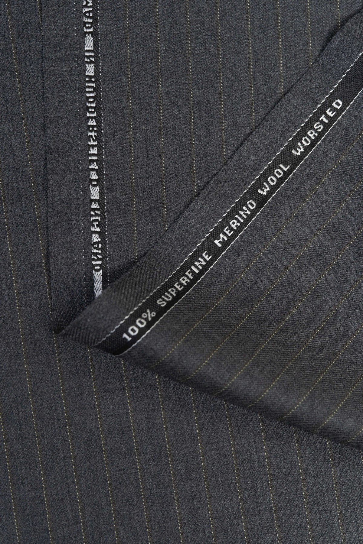 Close-up of Barrington Grey super merino wool suiting fabric with yellow stripe. Perfect for tailored suits.