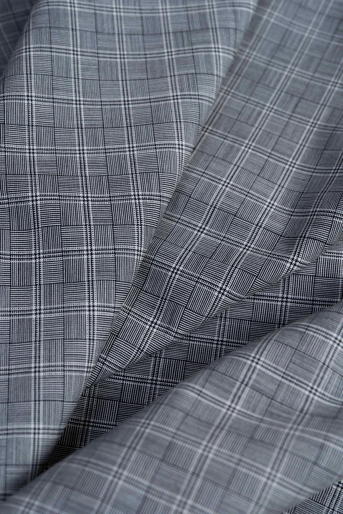 Barrington Panama Weave black-and-white check wool fabric close-up, showcasing unique patterns and textures.