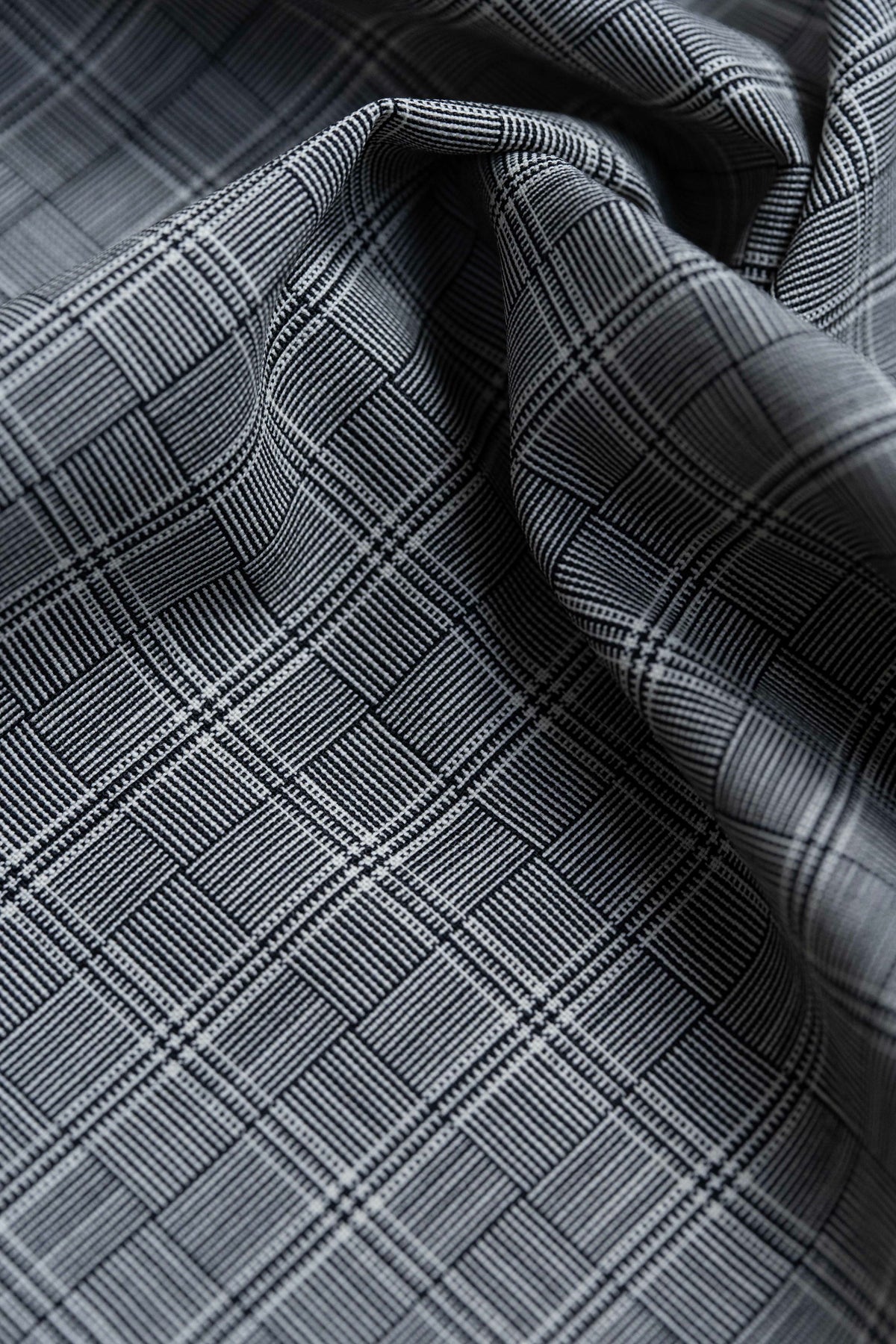 Close-up of Barrington Panama Weave black-and-white check wool fabric, showcasing a stylish grid pattern perfect for jackets.