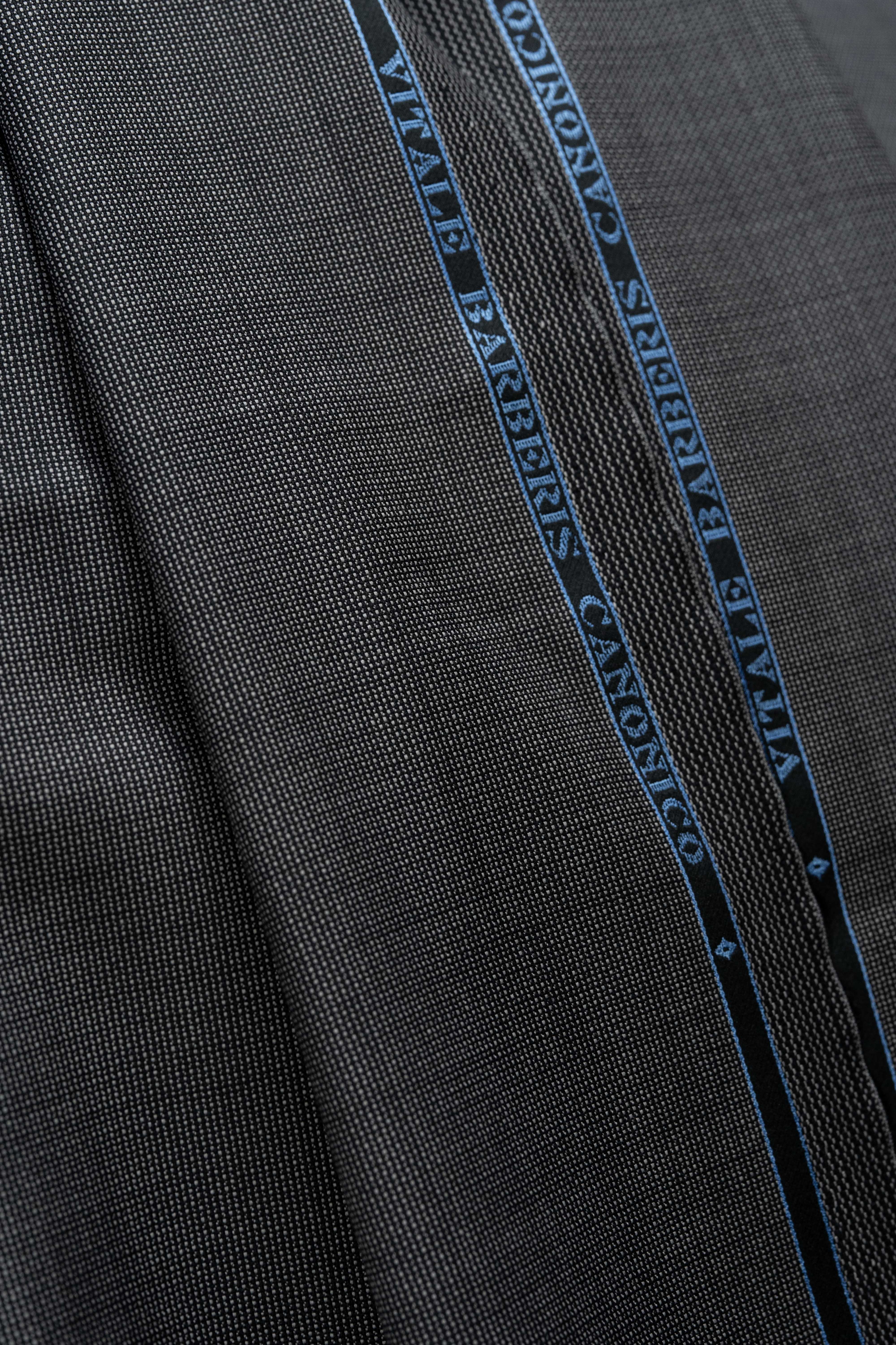VBC Lightweight Super 120's Wool Suit Fabric (V23730) showcasing a detailed texture and branded logo.