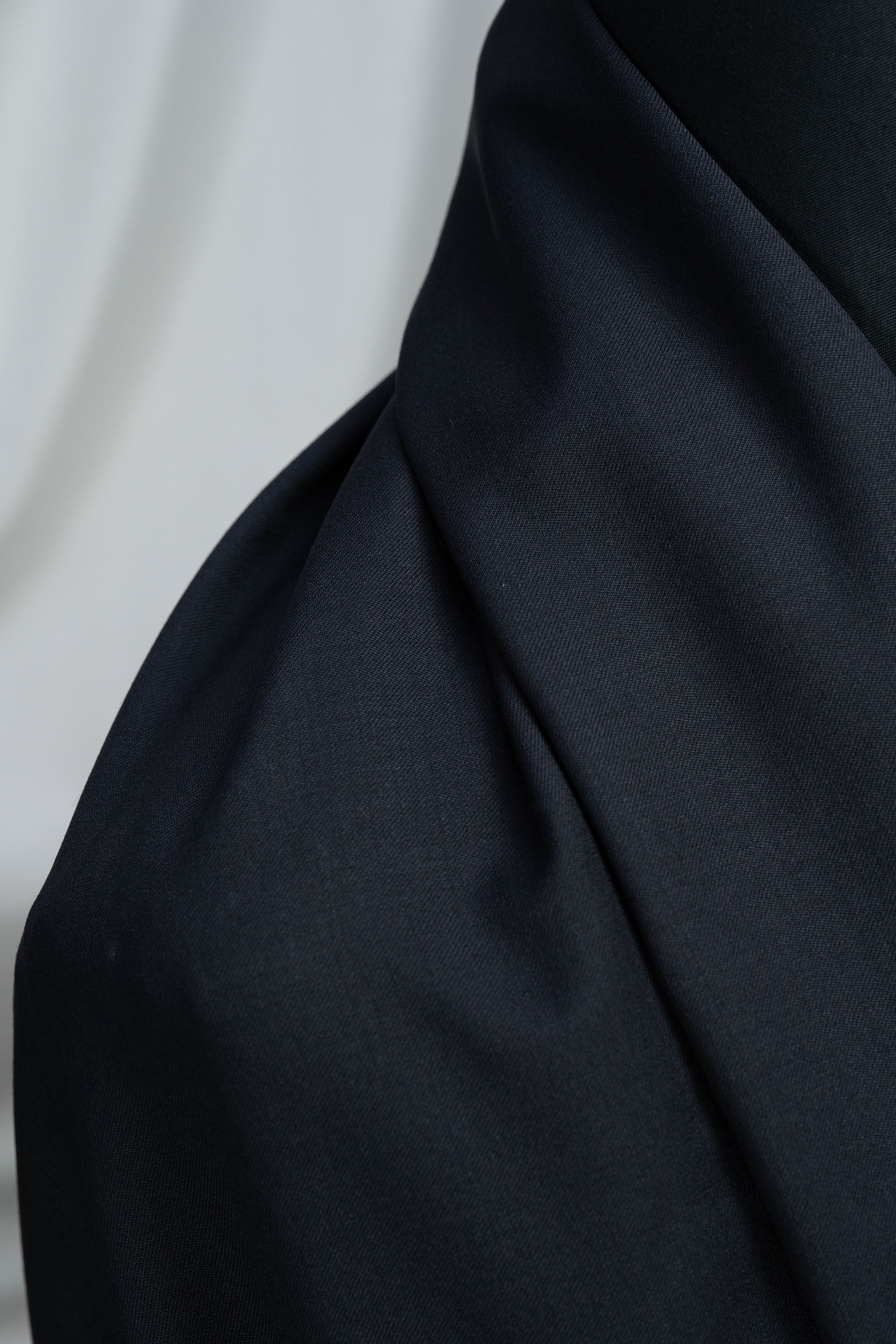 Close-up of England Black Super 100's Wool Suiting Fabric showing smooth texture and dark color.