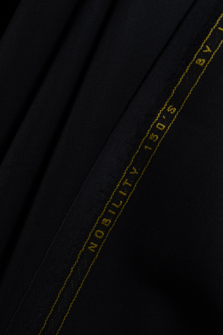 CERRUTI 1881 Black Plain Nobility Super 150's Wool Suiting-3 Meters fabric close-up with gold detailing.