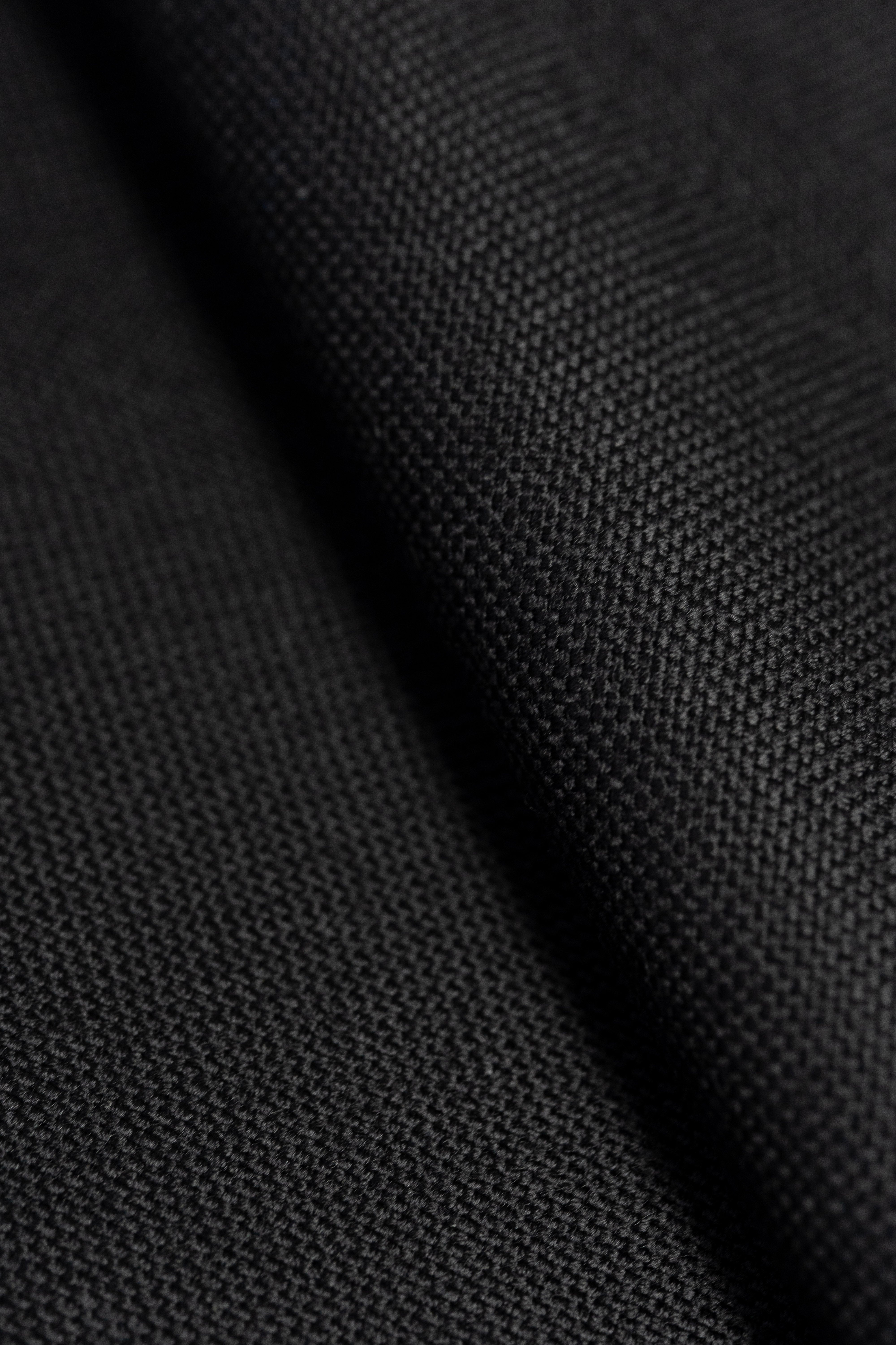 Groves & Lindley black wool suit fabric with a textured finish, perfect for tailored suits.