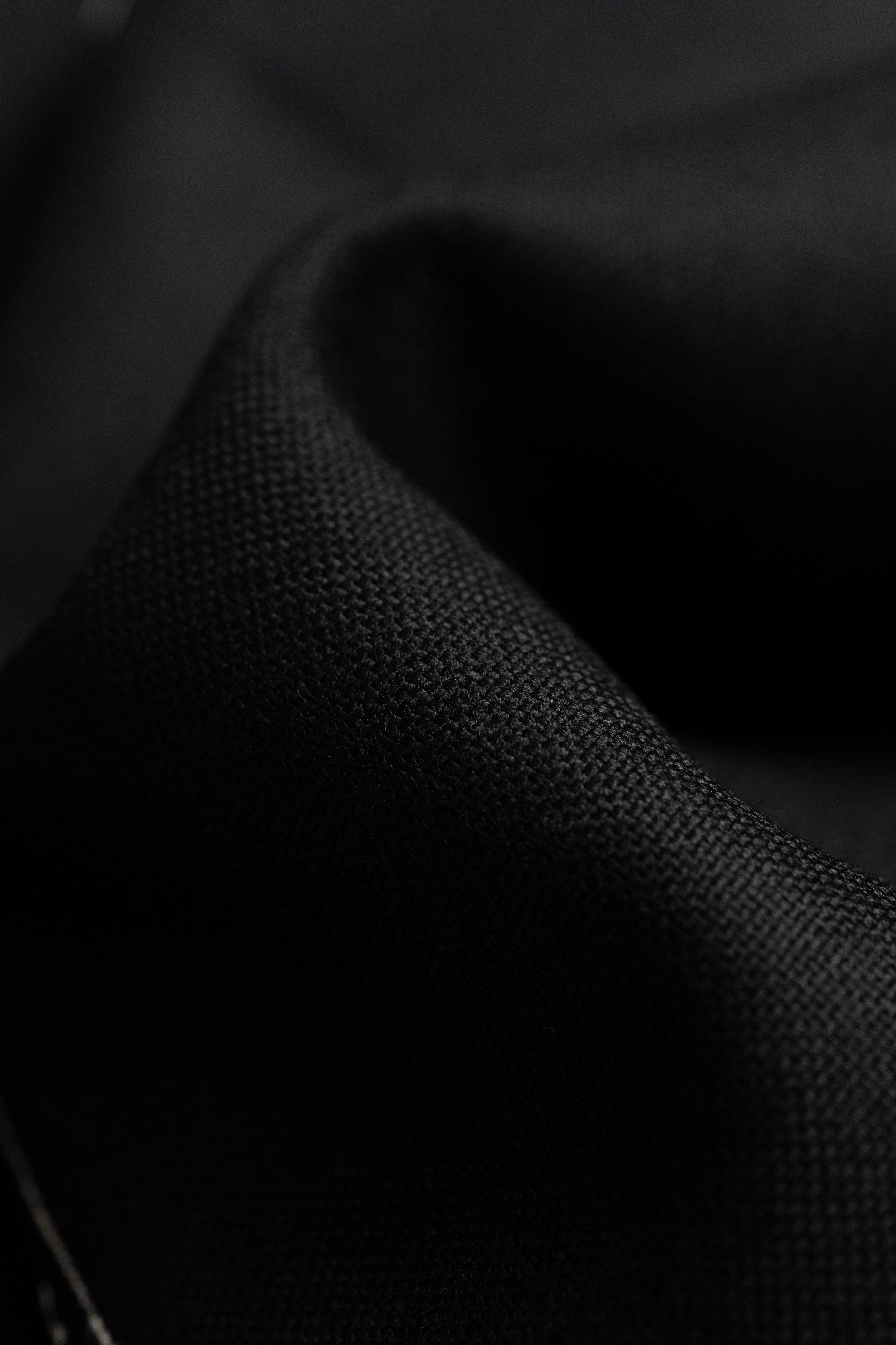 Close-up of Groves & Lindley black wool suit fabric, showcasing a luxurious texture of 2.3 meters.