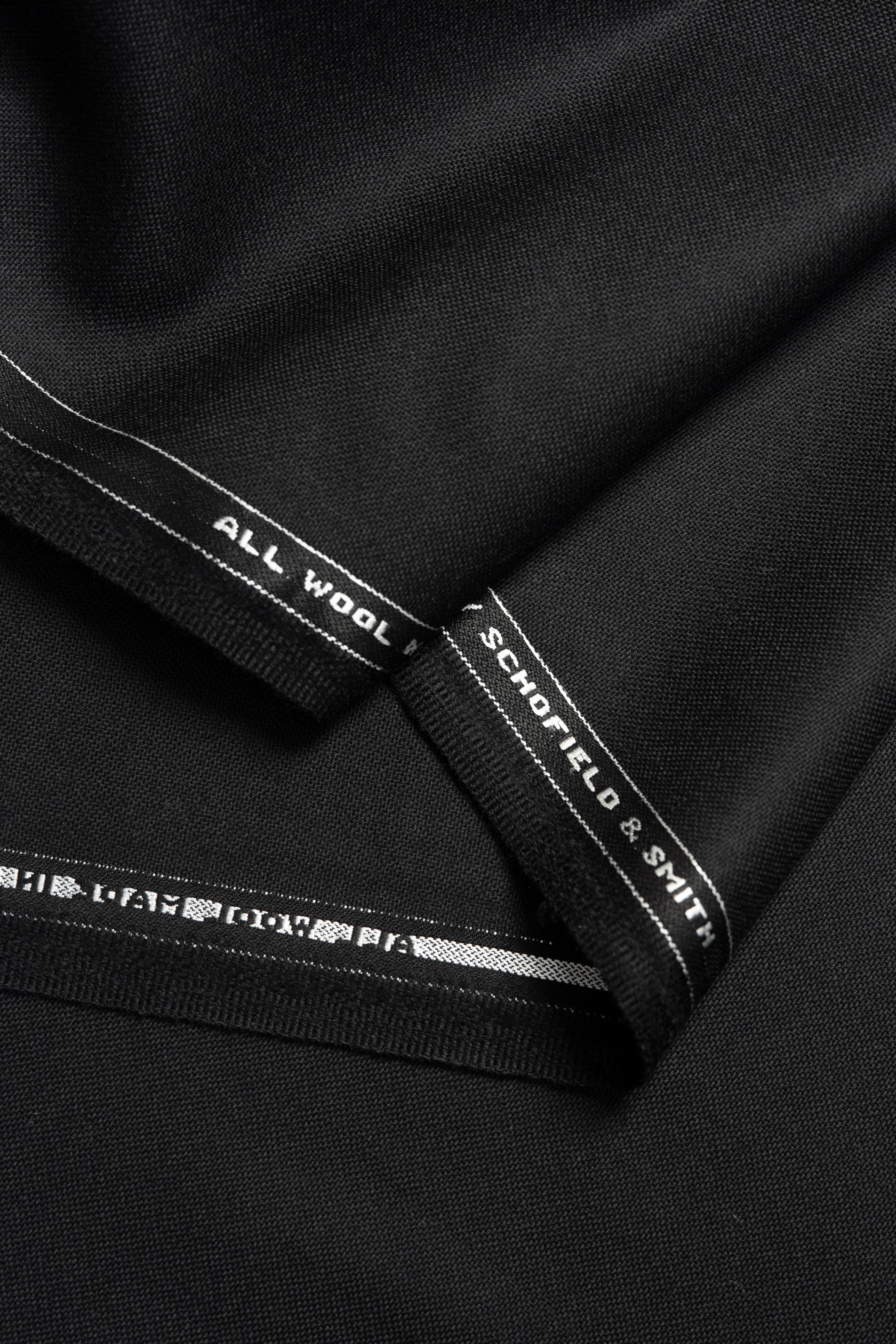 Groves & Lindley plain worsted black wool suit fabric, showcasing luxurious all wool texture.