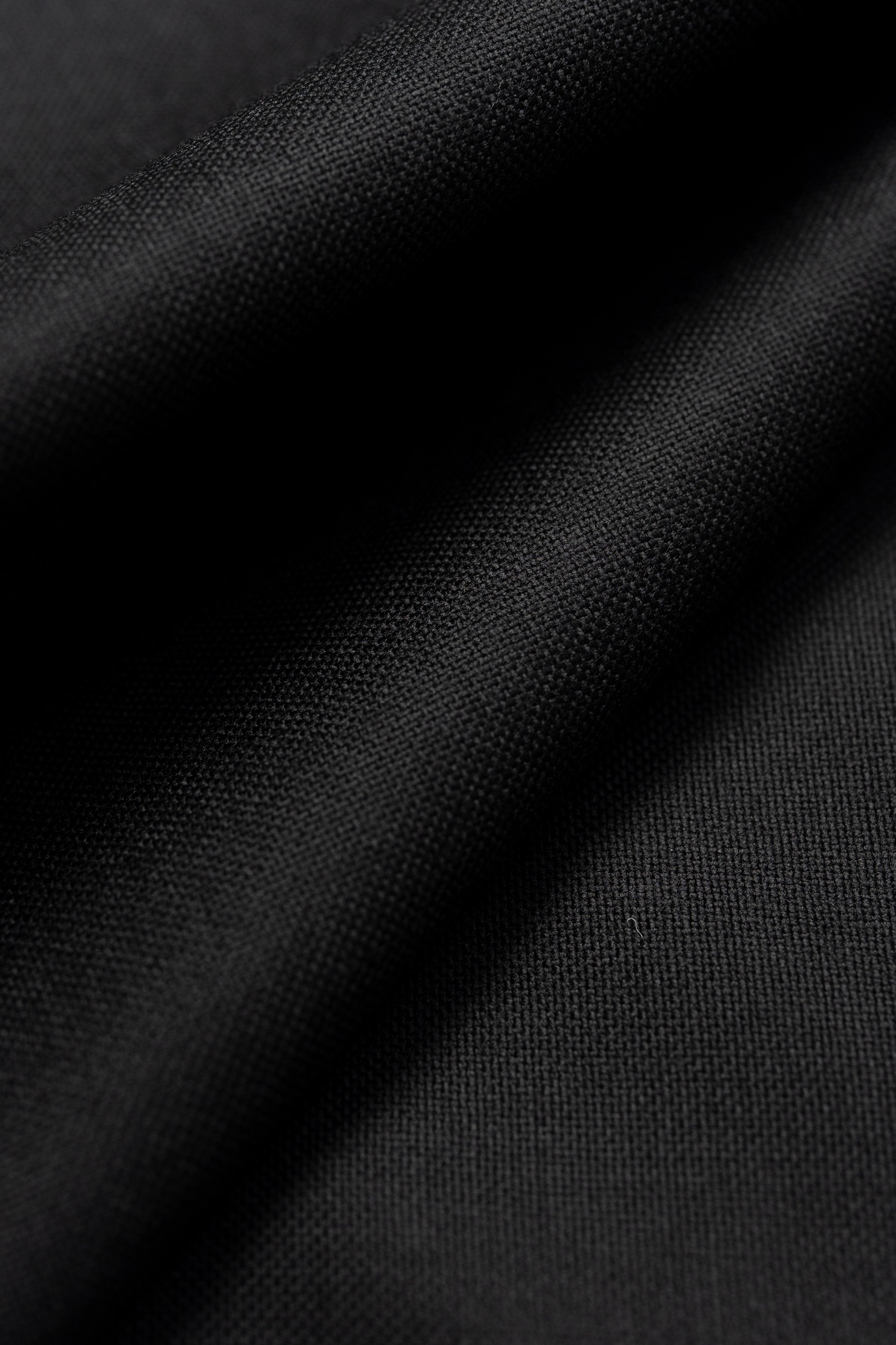 close-up of Groves & Lindley black wool suit fabric showcasing its texture and quality