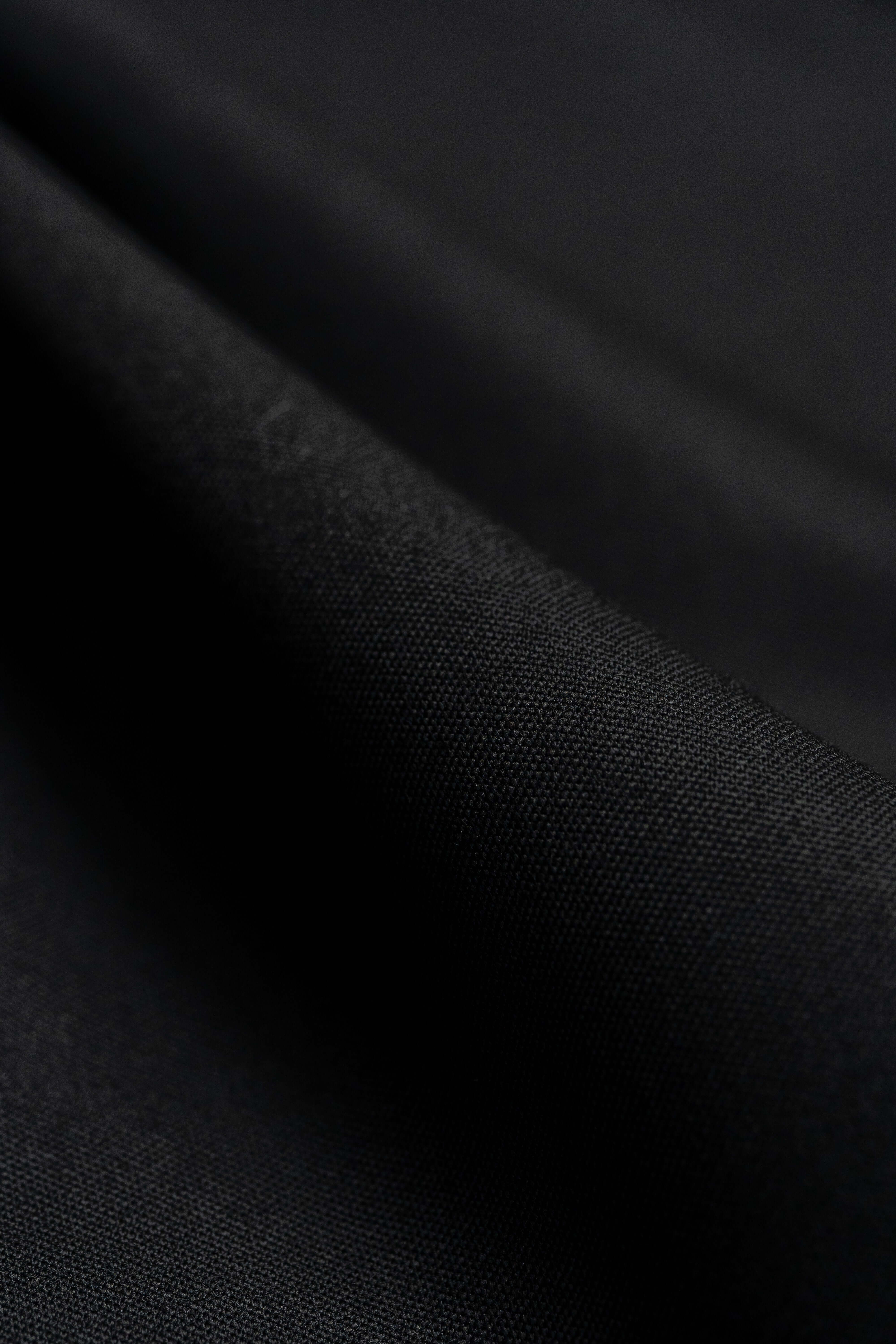 Close-up of Groves & Lindley black wool suit fabric showcasing its fine texture and quality.