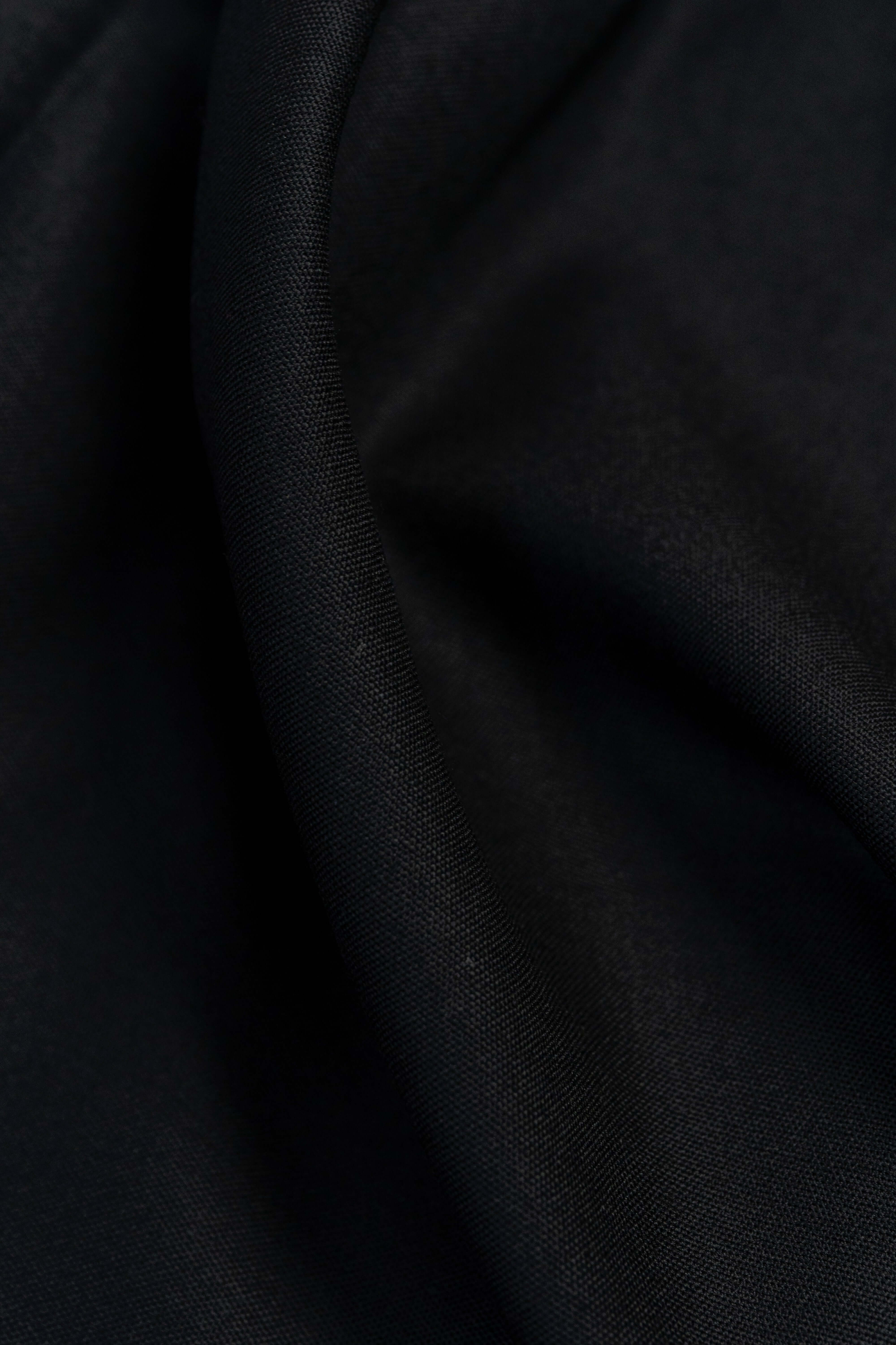 Close-up of Groves & Lindley Super 120's black wool suit fabric, showcasing its smooth texture and rich color.