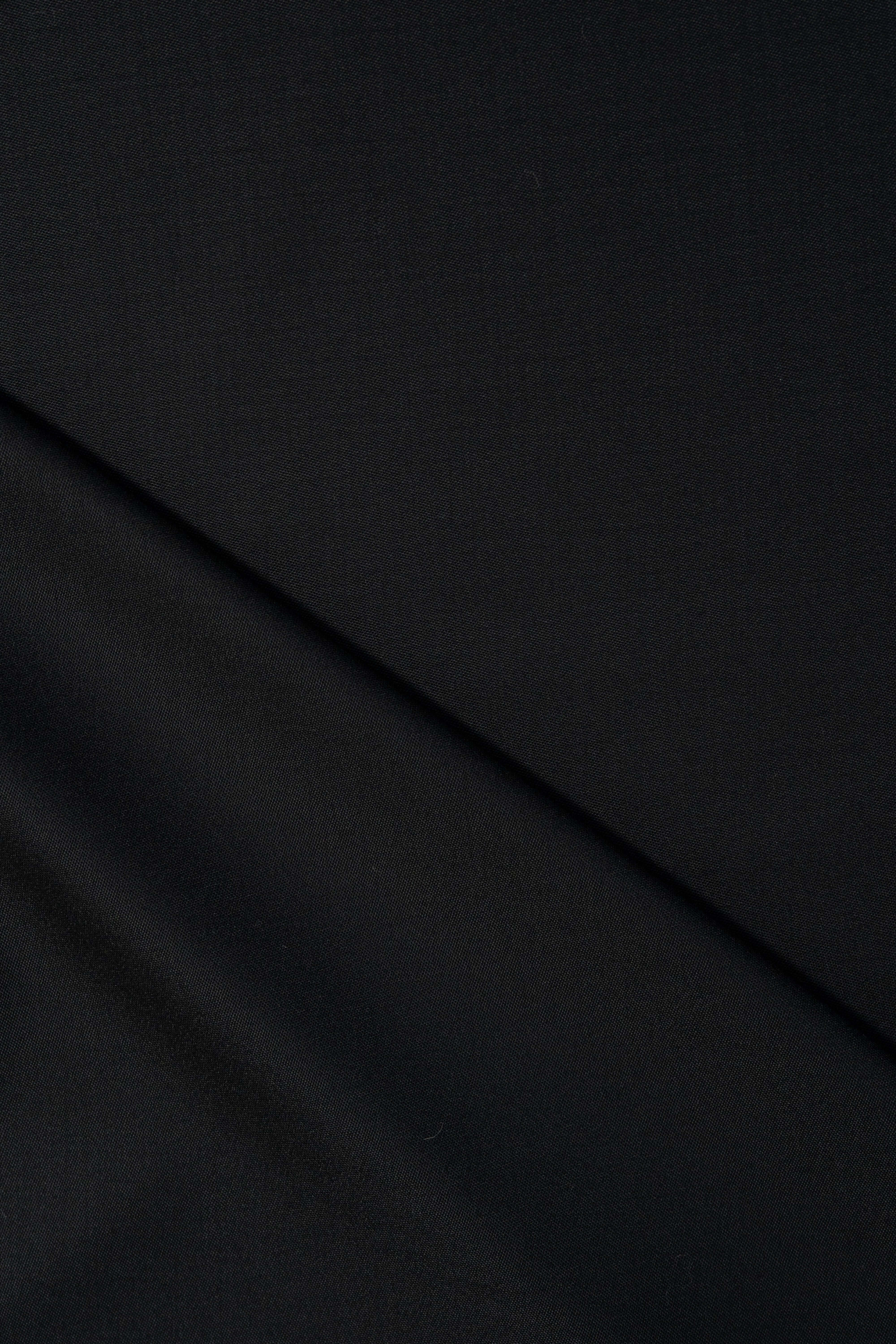 Groves & Lindley Super 120's worstand plain black wool suit fabric texture close-up.