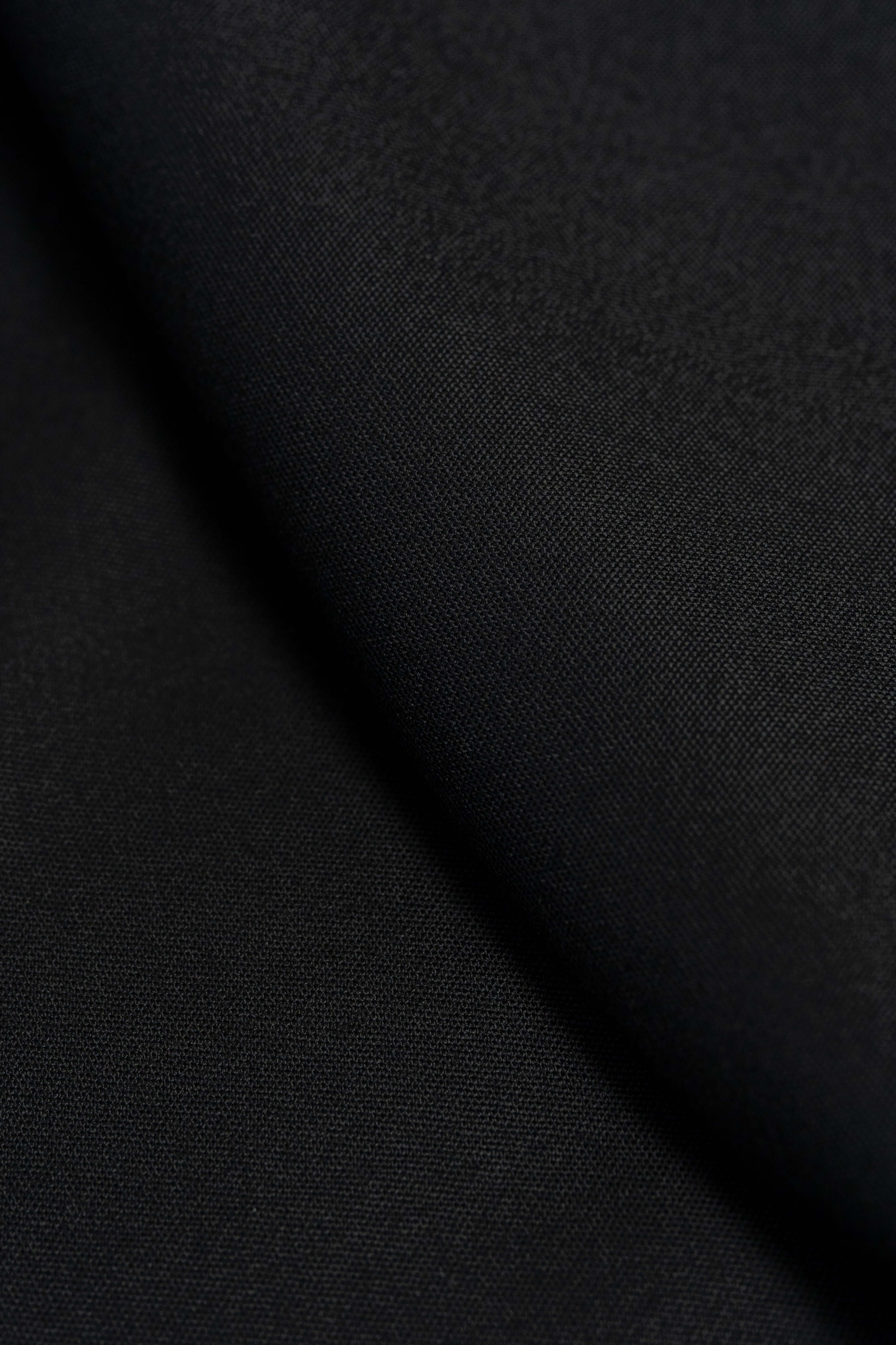 Groves & Lindley Super 120's worsted black wool suit fabric, displaying a smooth, elegant texture in rich black.