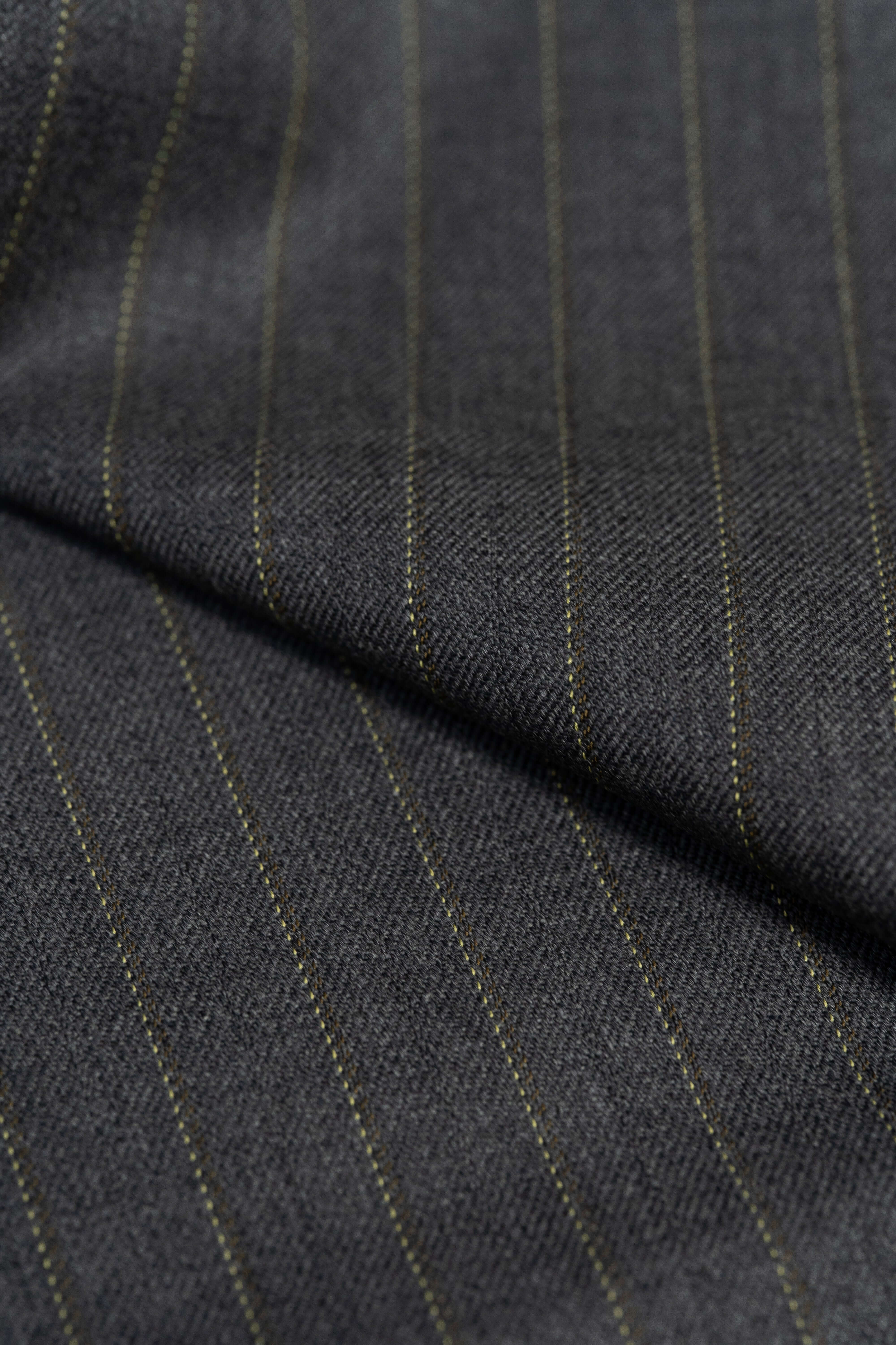 Close-up of Barrington Grey super merino wool suiting fabric with yellow stripe, showcasing its fine texture and stripes.