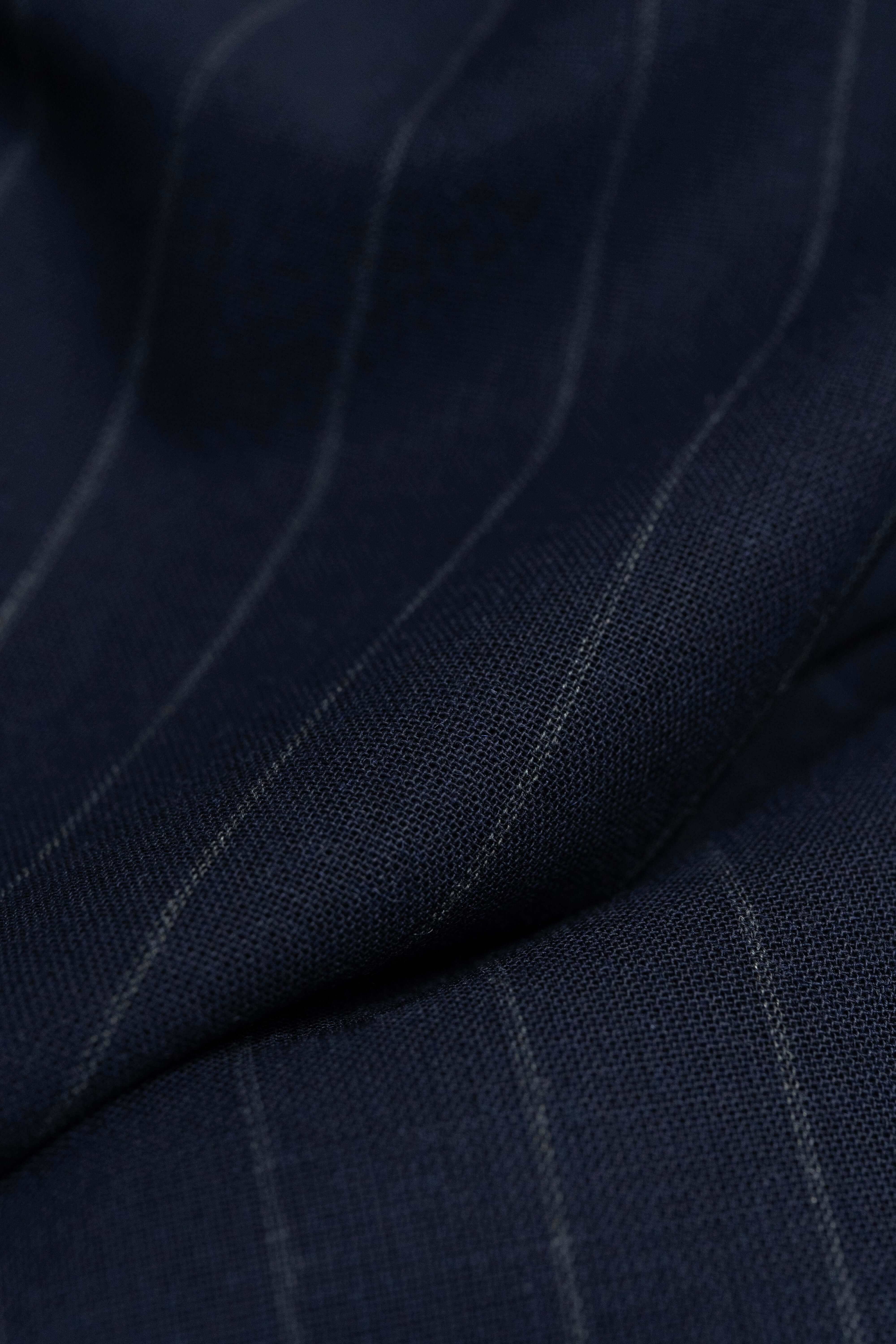 close-up of Groves & Lindley dark blue stripe wool mohair suiting fabric with fine pinstripes