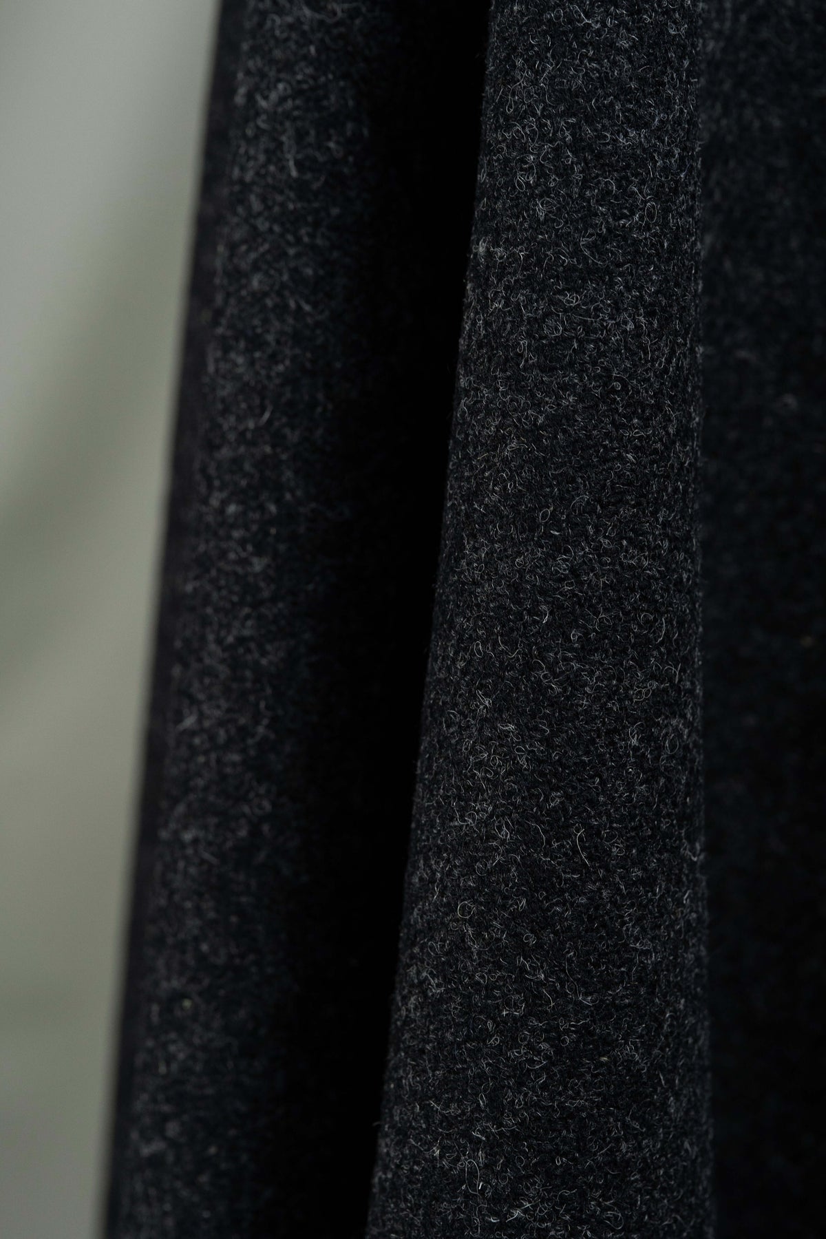 Dark charcoal heavy woolen fabric showcasing British Red Stripe Wool Suit Fabric, perfect for tailored suits.