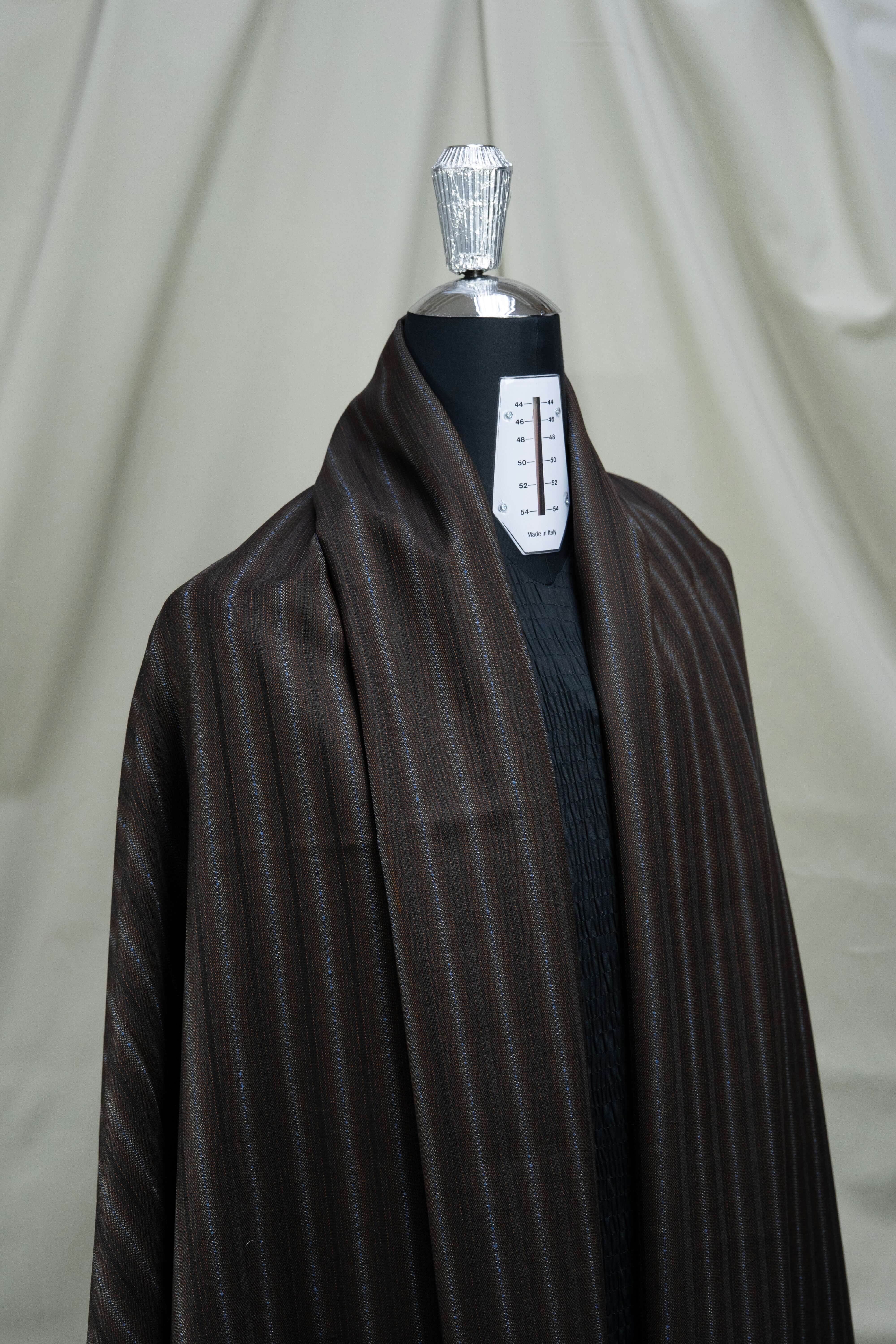 England brown stripe wool suiting fabric draped on a mannequin, showcasing a sophisticated striped design.