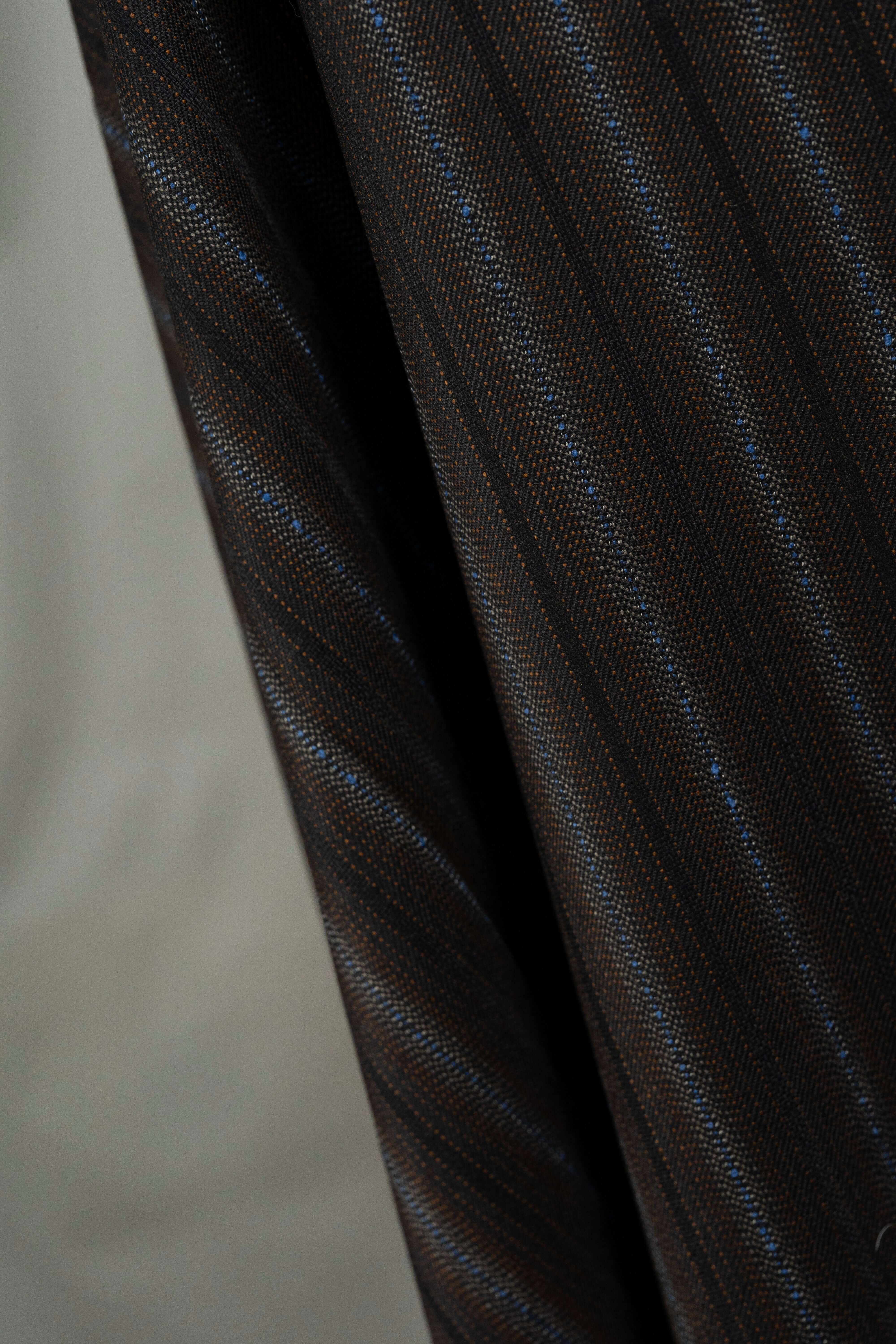 England brown stripe wool suiting fabric draped to showcase the elegant texture and design, perfect for tailored suits.