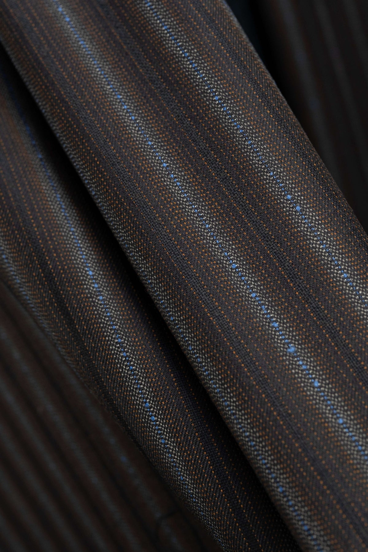 England brown stripe wool suiting fabric displayed in a close-up view, highlighting its rich texture and elegant design.