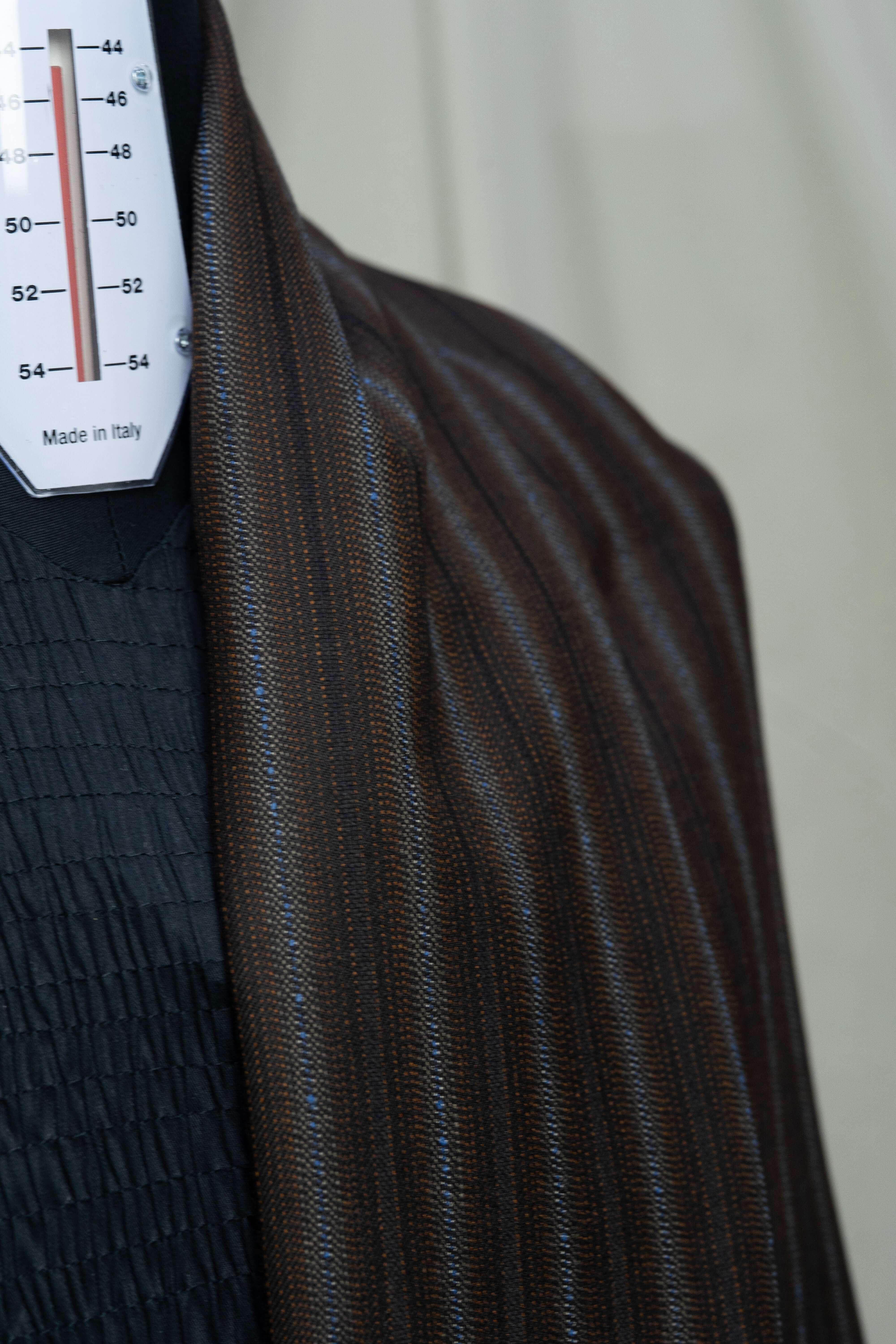 Close-up of England brown stripe wool suiting fabric showing fine texture and pattern.