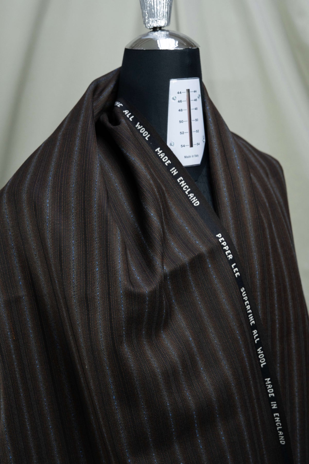 England Brown Fancy Stripe Wool Suiting -3 Meters, showcasing brown stripe wool suiting fabric draped on a mannequin.