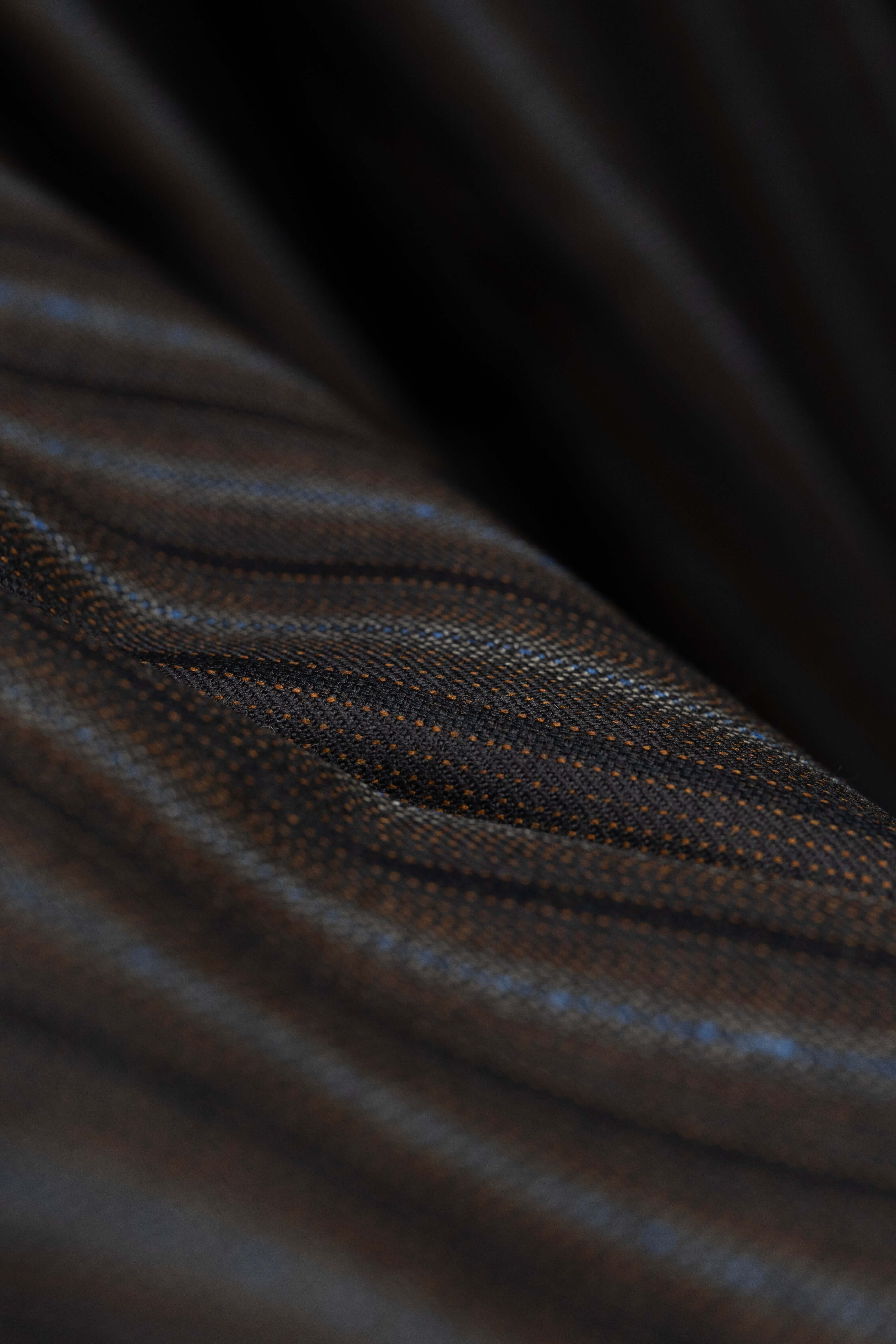 Close-up of England brown stripe wool suiting fabric showcasing its rich texture and elegant stripes.