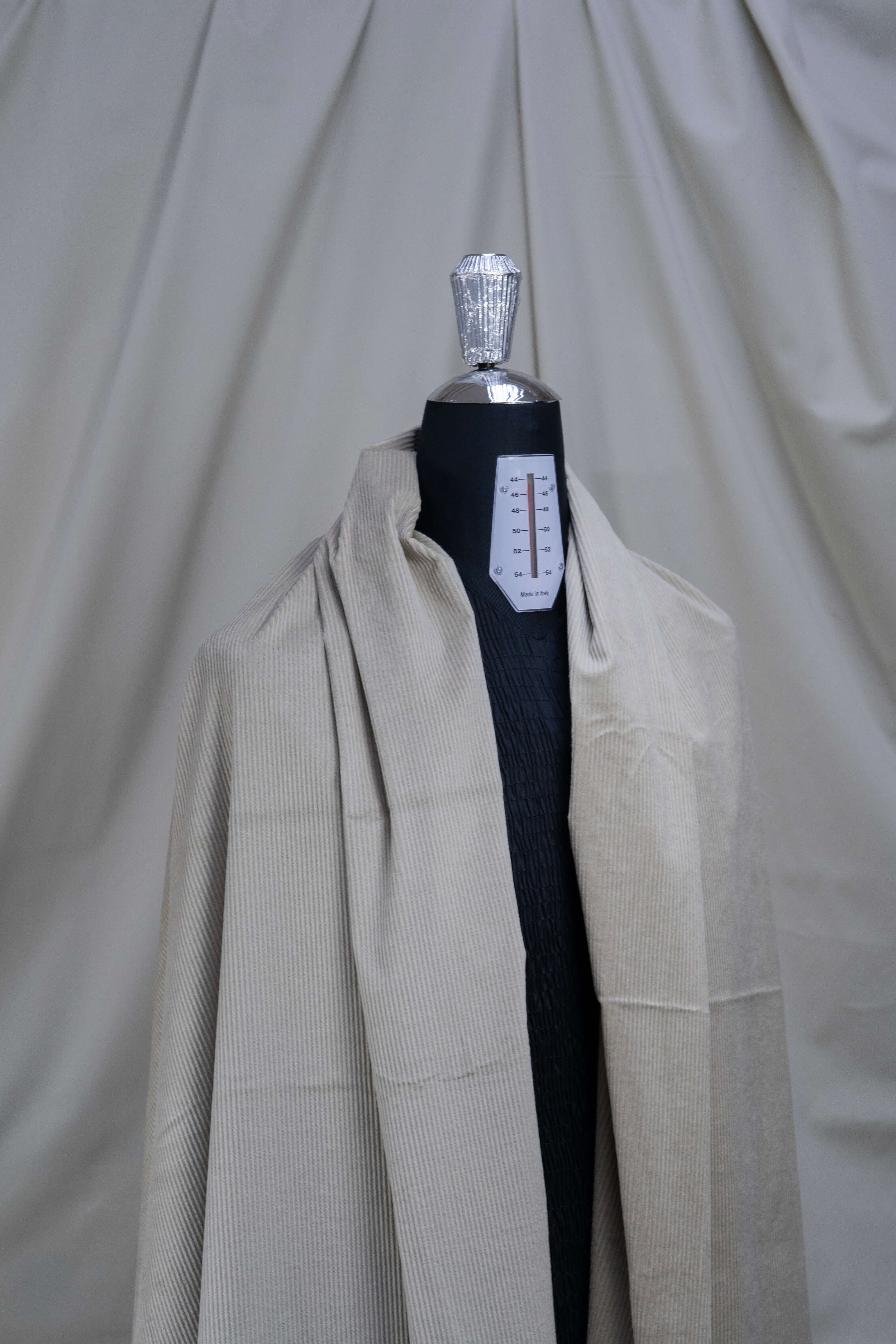 PONTOGLIO 1883 cotton cashmere corduroy suiting fabric displayed on a dress form, showcasing its texture and color.