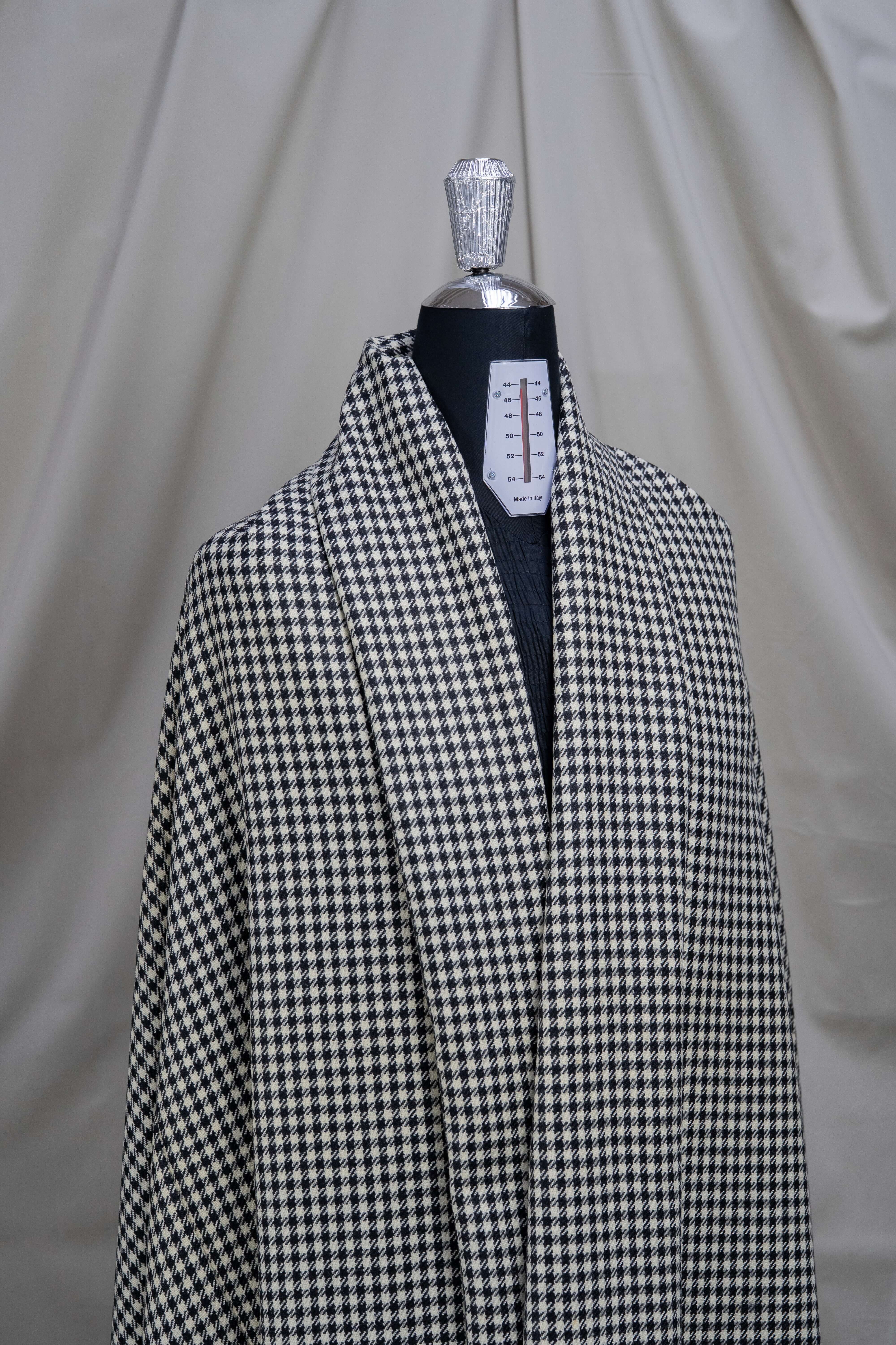 Houndstooth wool jacketing fabric displayed on a mannequin, showcasing its stylish pattern and quality texture.