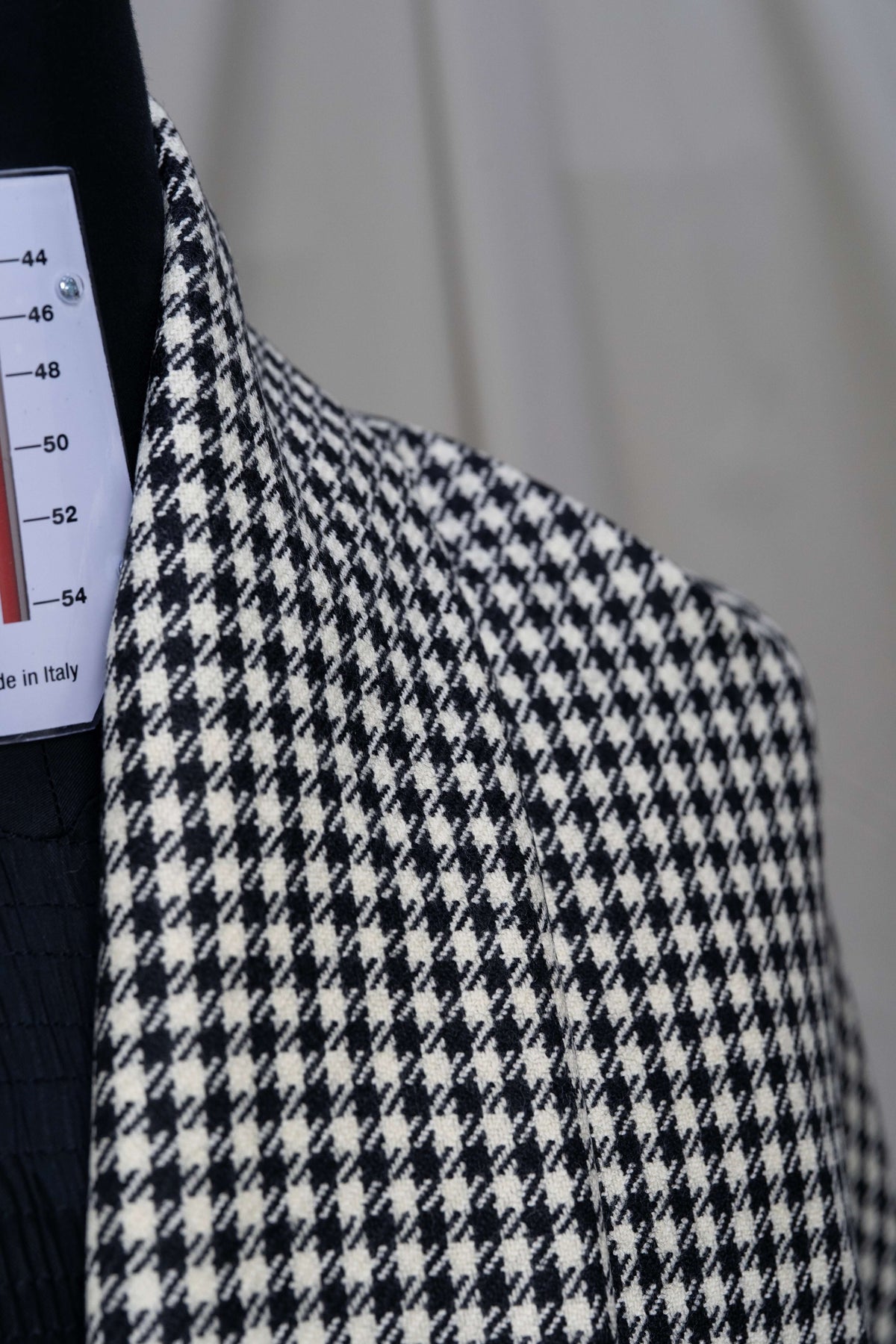Close-up of houndstooth wool jacketing fabric revealing rich texture and pattern detail.