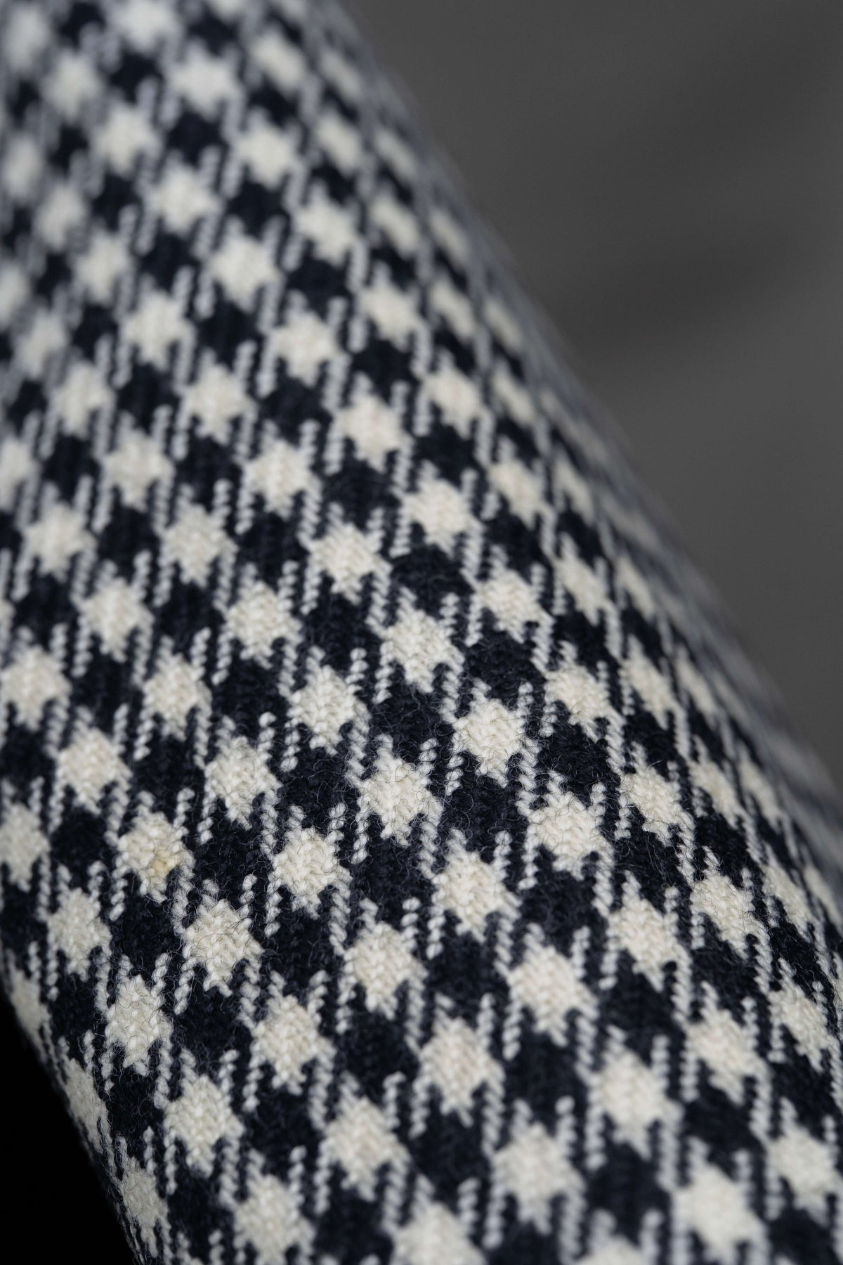 Houndstooth wool jacketing fabric with a close-up view of the classic pattern in black and white.