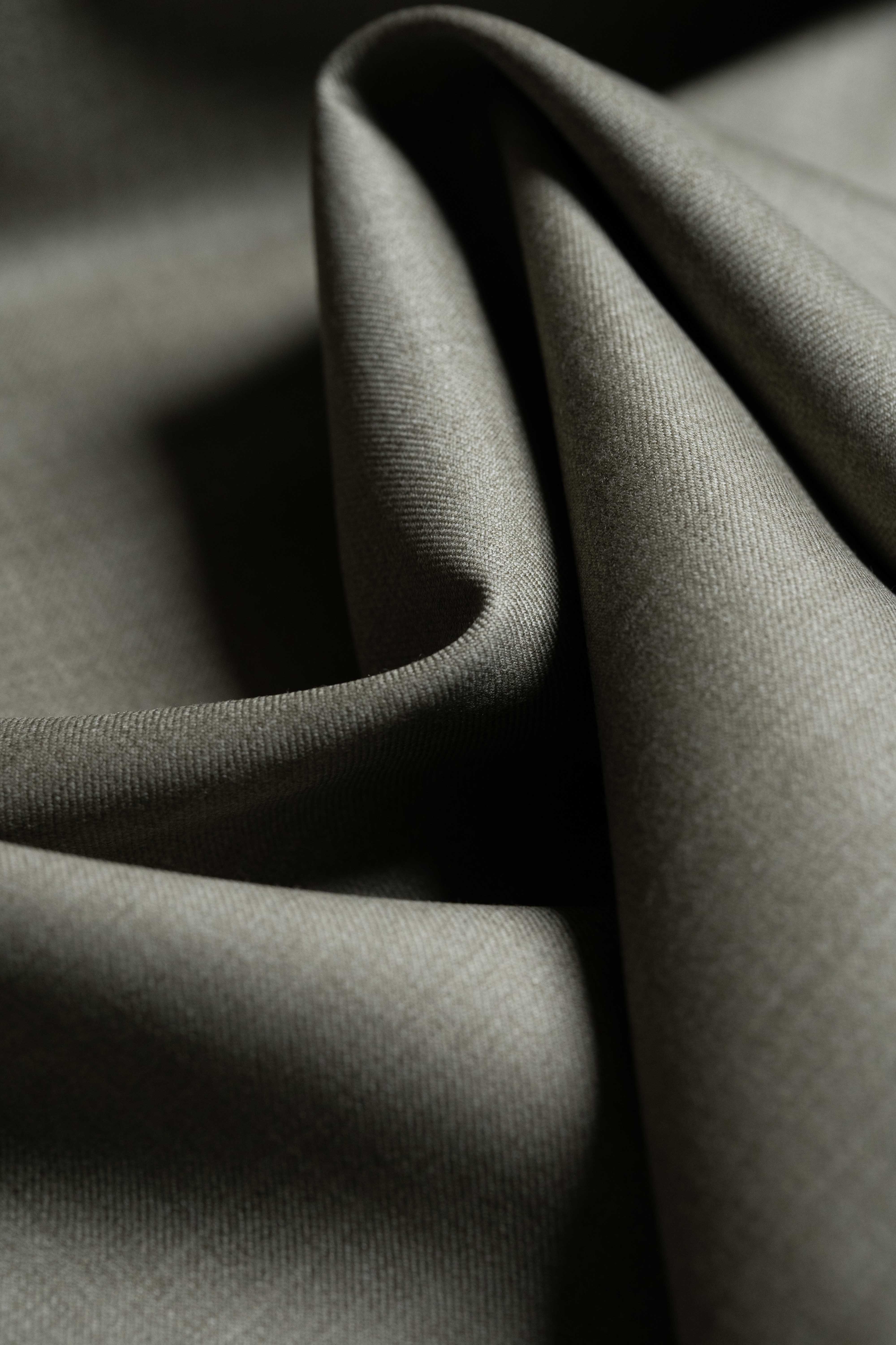 Loro Piana taupe Australian 150's merino wool suit fabric close-up showcasing its smooth texture.