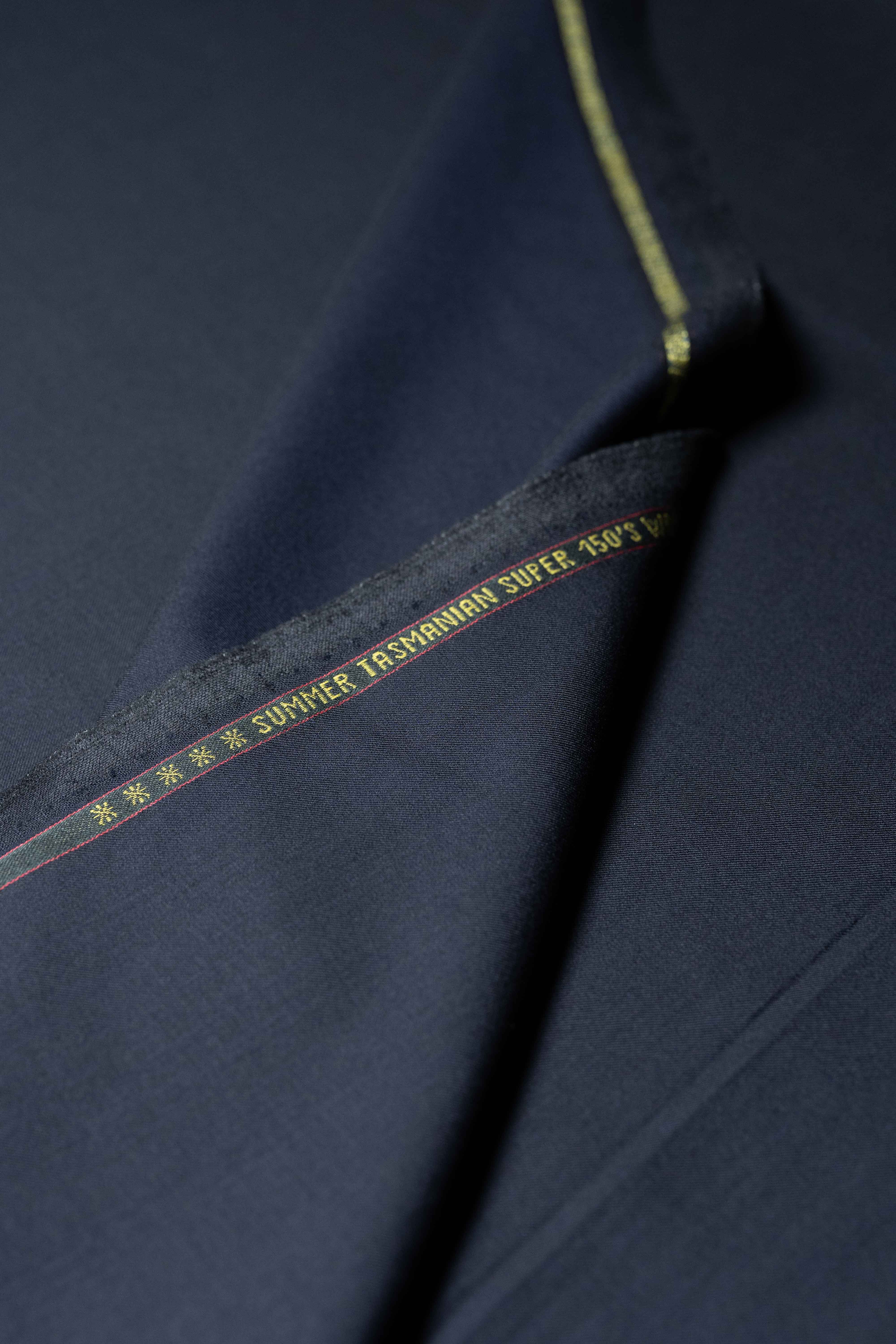 Loro Piana Midnight Navy Tasmanian 150's wool and silk fabric detail with a tight weave and elegant finish.
