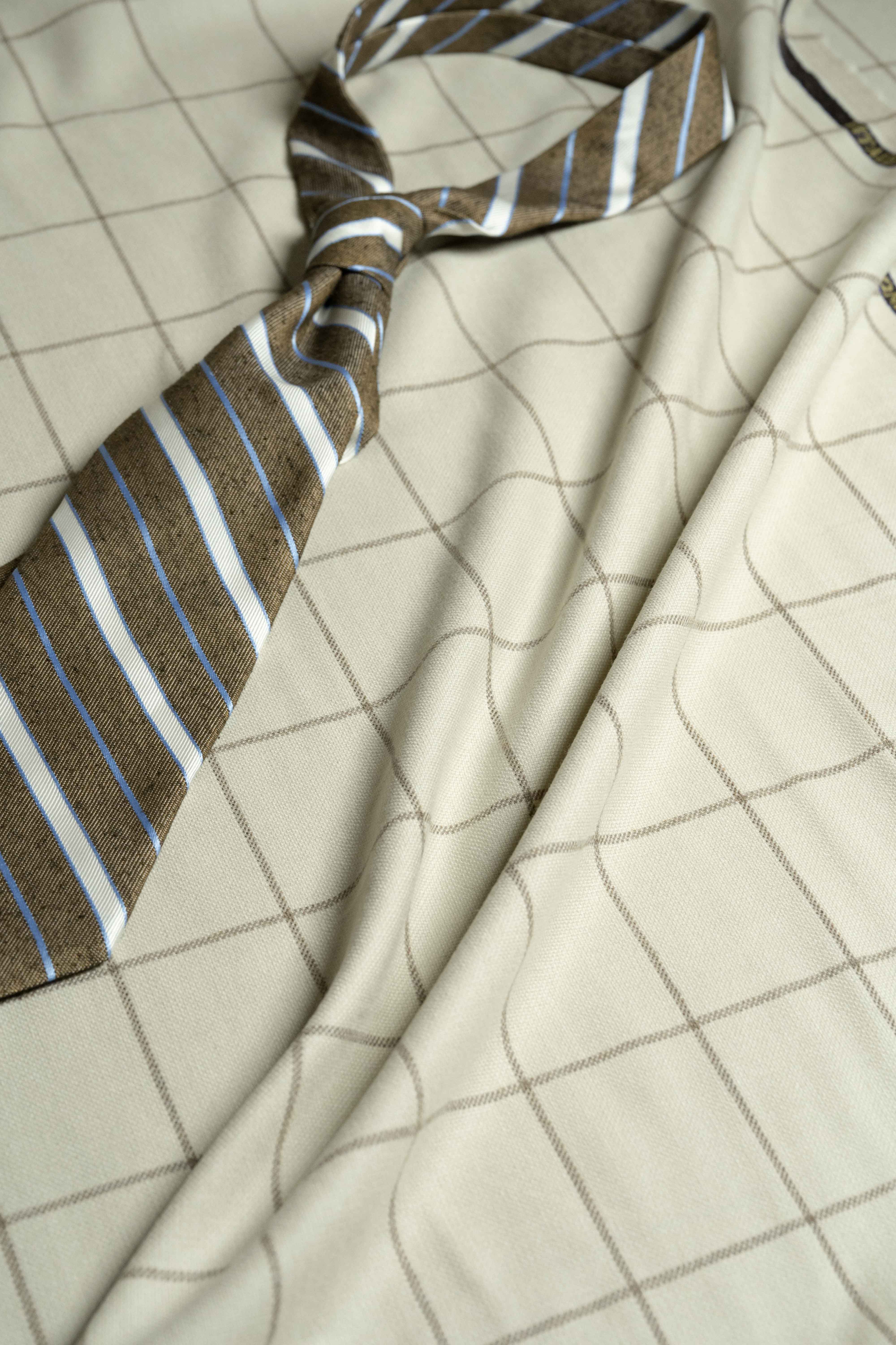 VBC Beige Check Wool & Cashmere Jacketing with a stylish tie, showcasing luxurious fabric and timeless design.