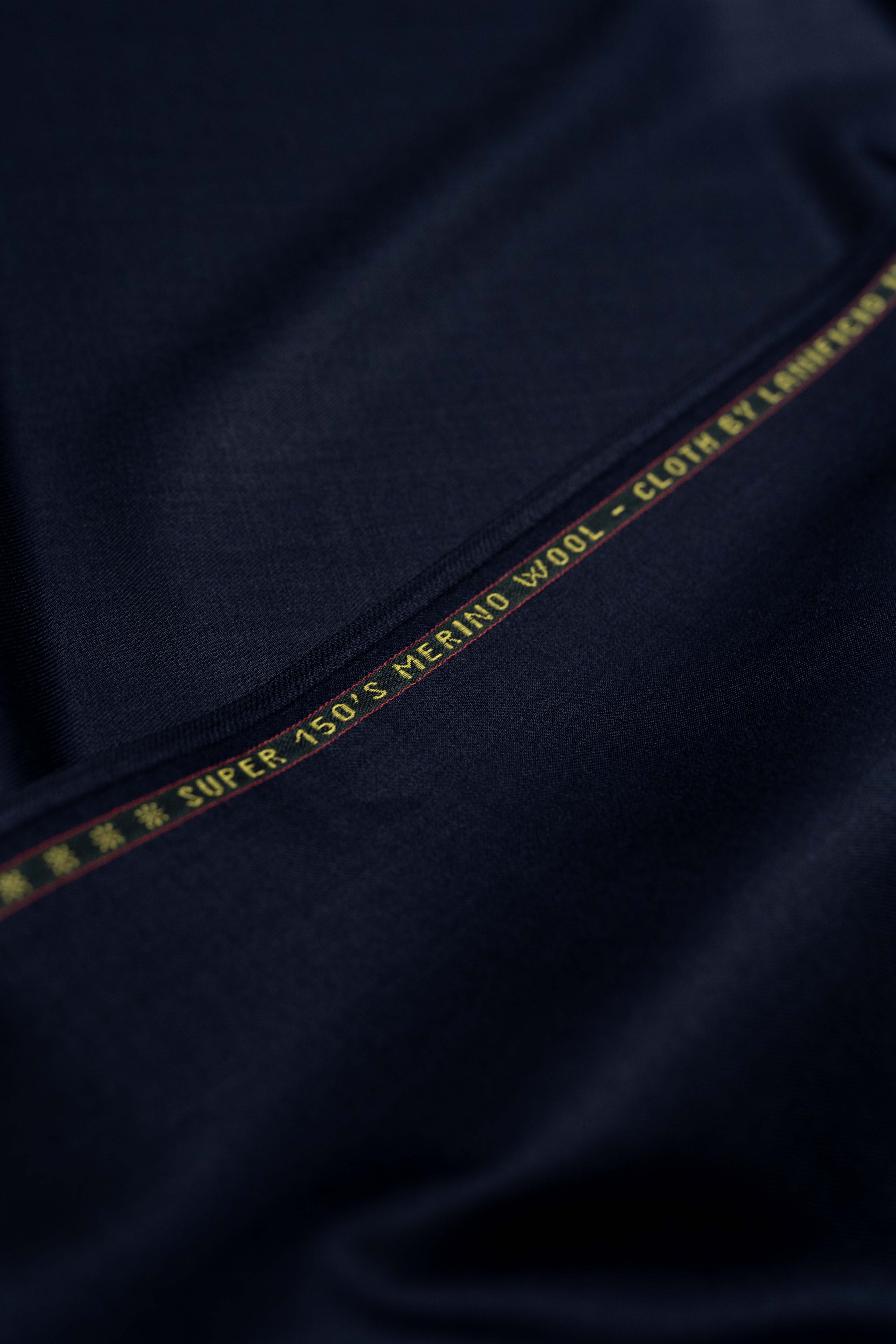 Loro Piana Dark Navy suit fabric made from luxurious Super 150's Merino wool, showcasing a refined texture and quality.