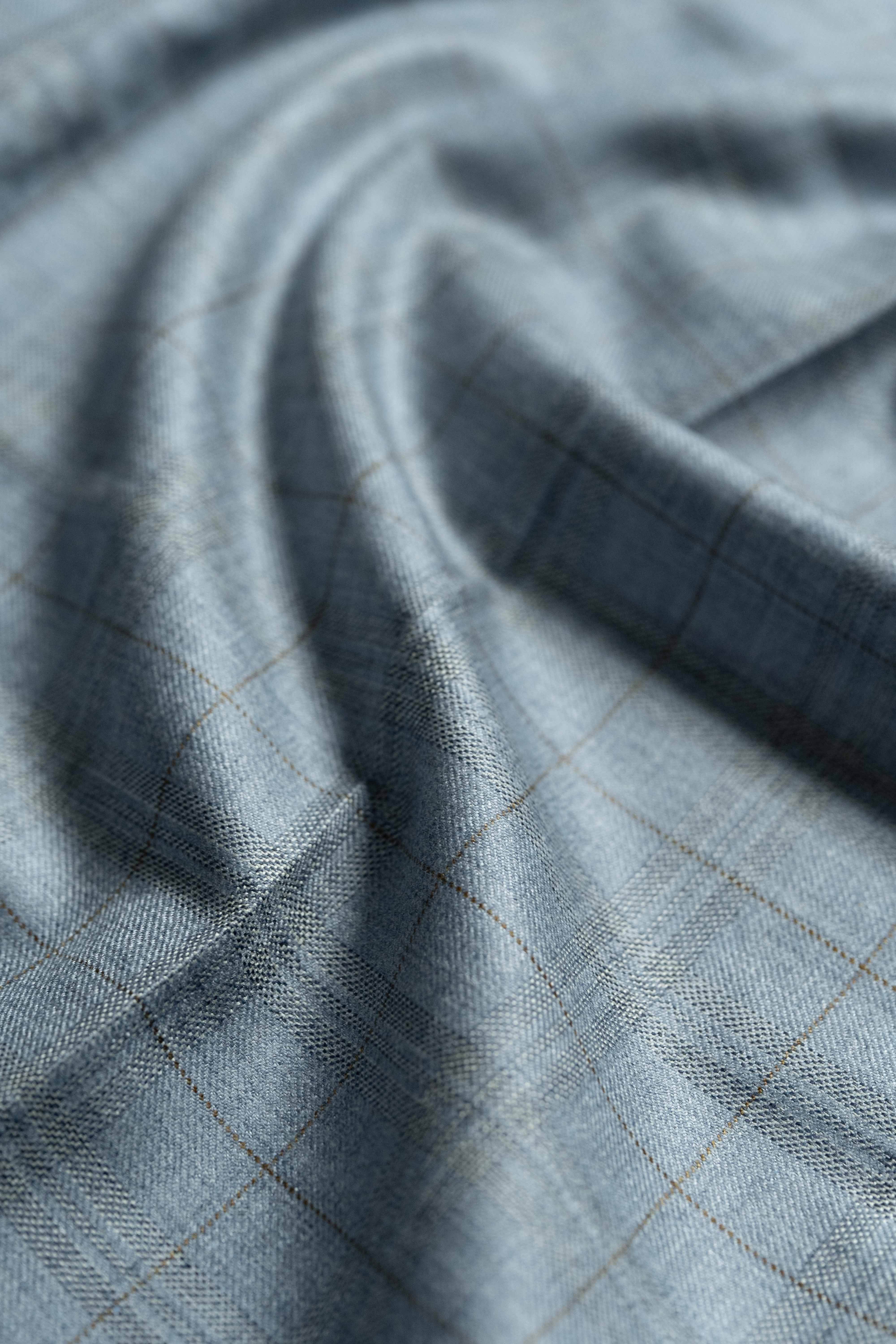 Loro Piana Light Blue Cashmere Silk Jacket Fabric showcasing a smooth, luxurious texture with subtle grid pattern.
