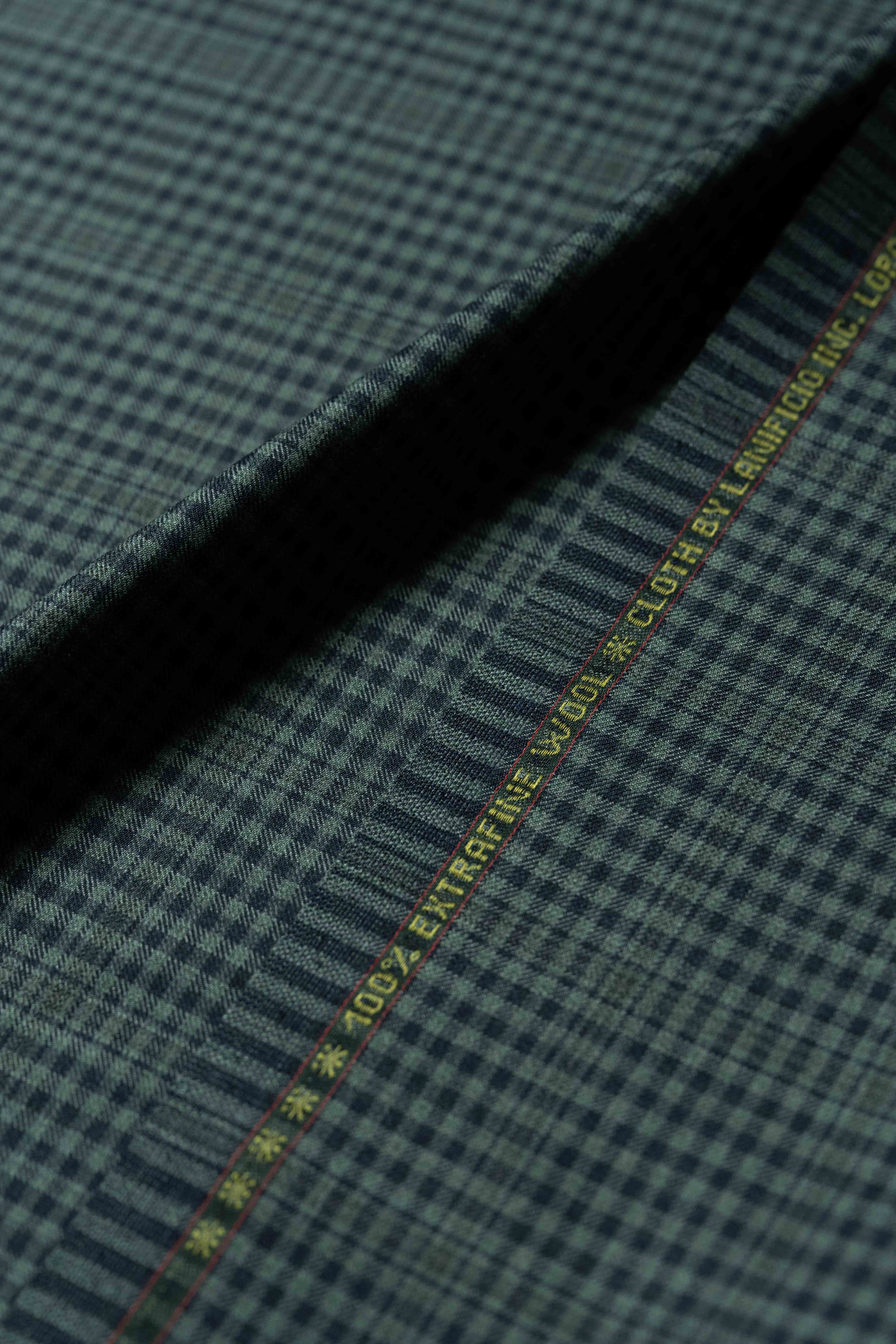 Loro Piana dark teal wool jacket fabric showcasing a refined check pattern, ideal for luxurious tailoring.