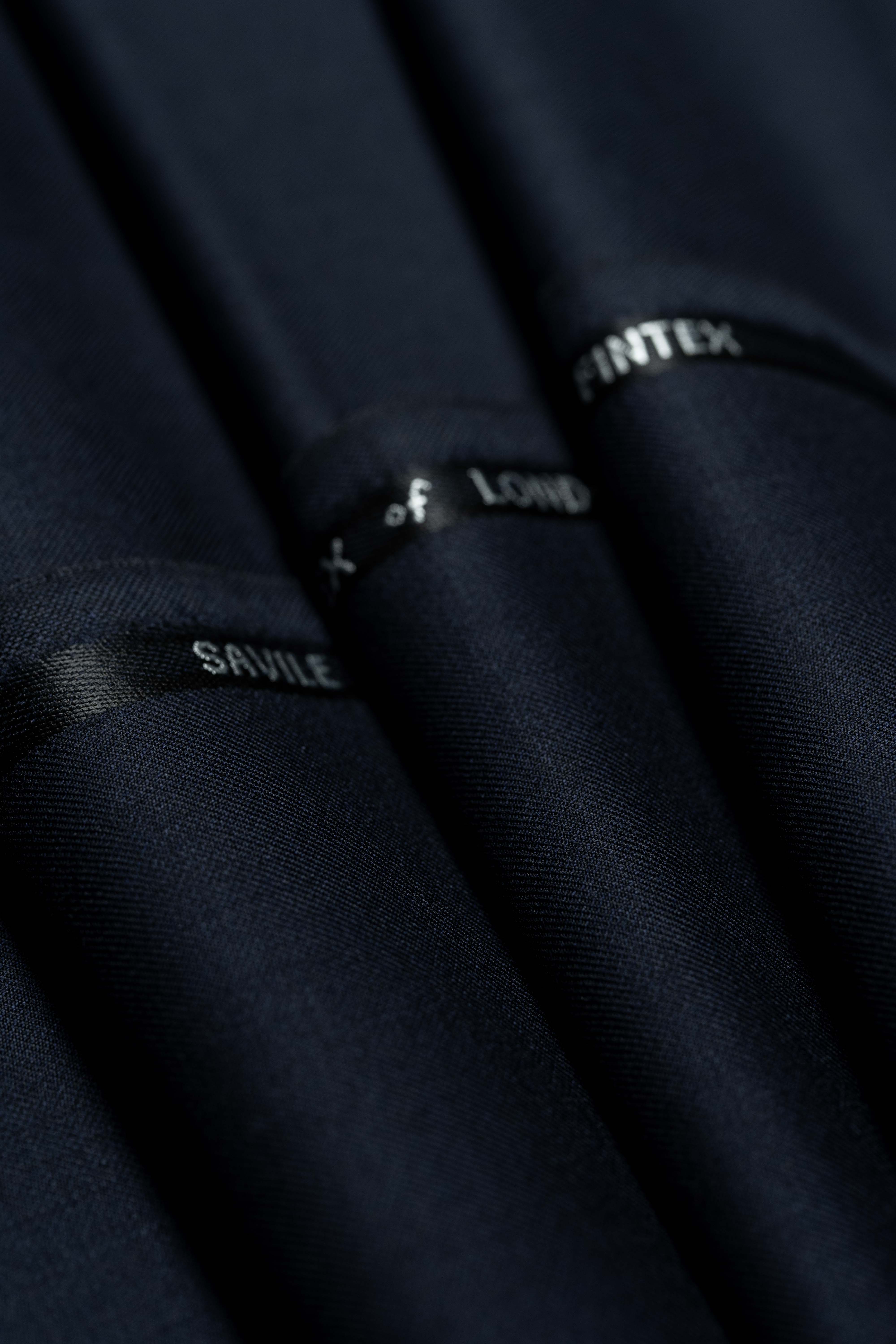 Fintex of London Midnight Navy wool suit fabric with Savile labels on the cloth.