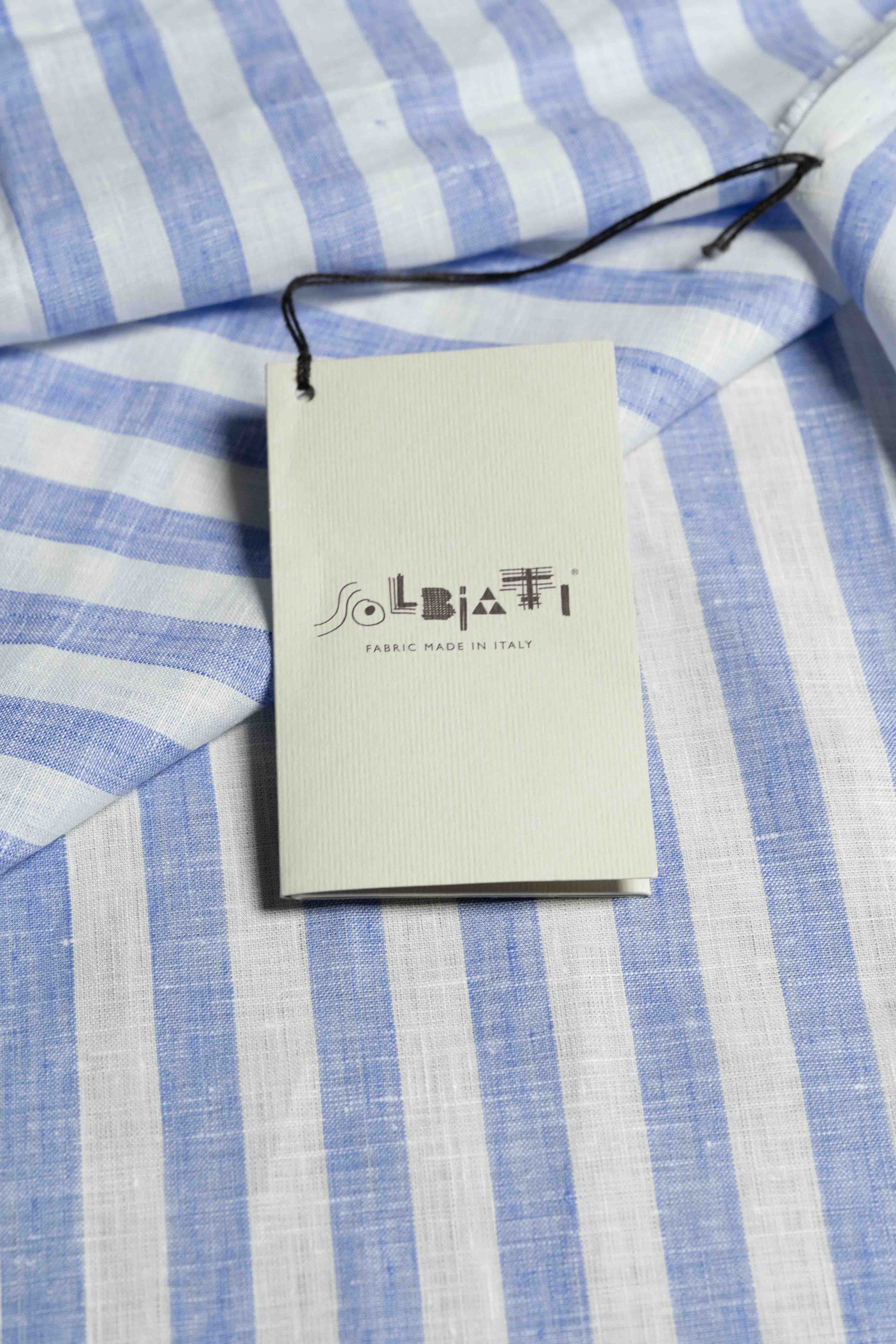 Solbiati light blue stripe linen fabric with tag, made in Italy, perfect for warm-weather wardrobe.