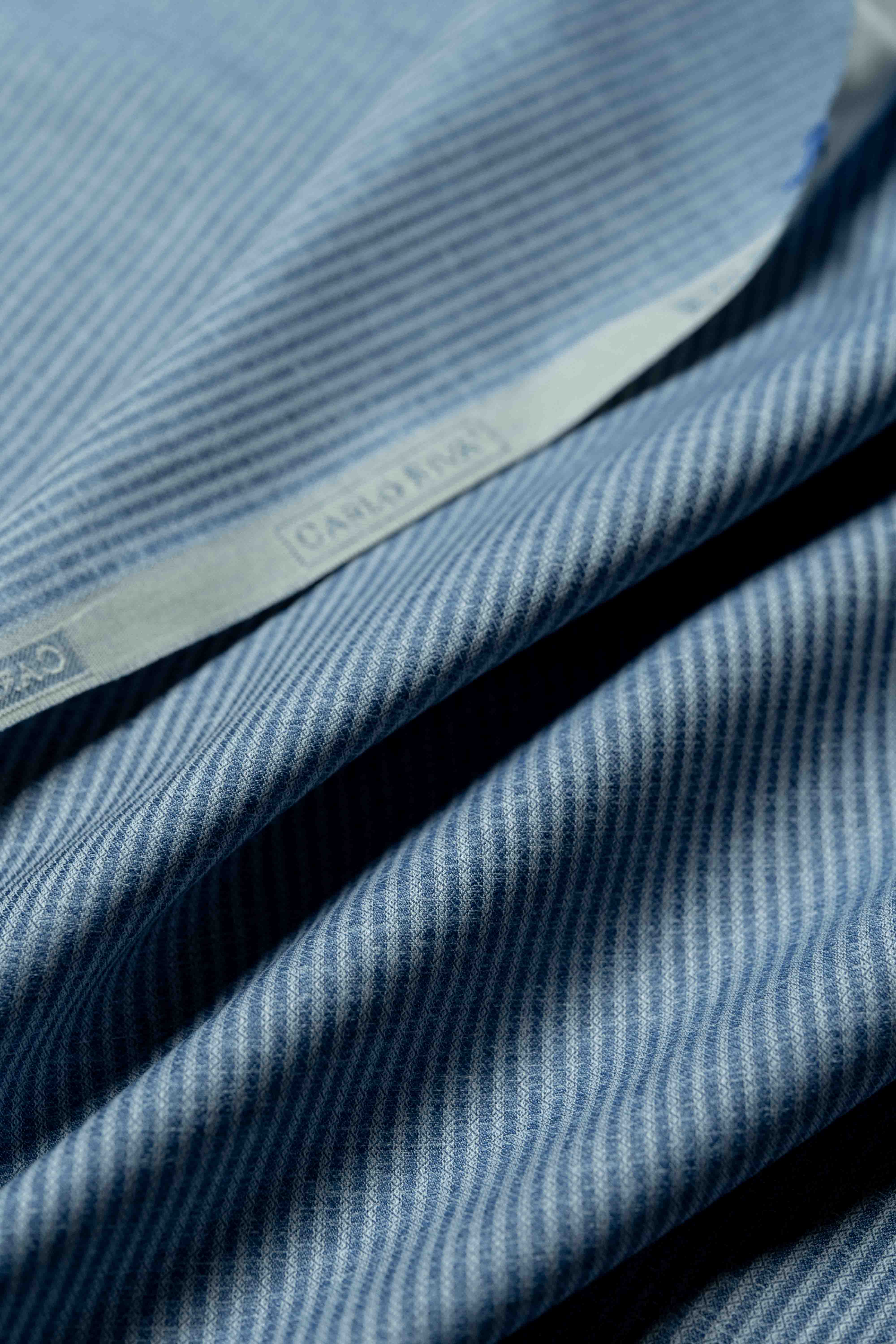 Carlo Riva blue stripe shirt fabric close-up showing detailed texture and pattern.