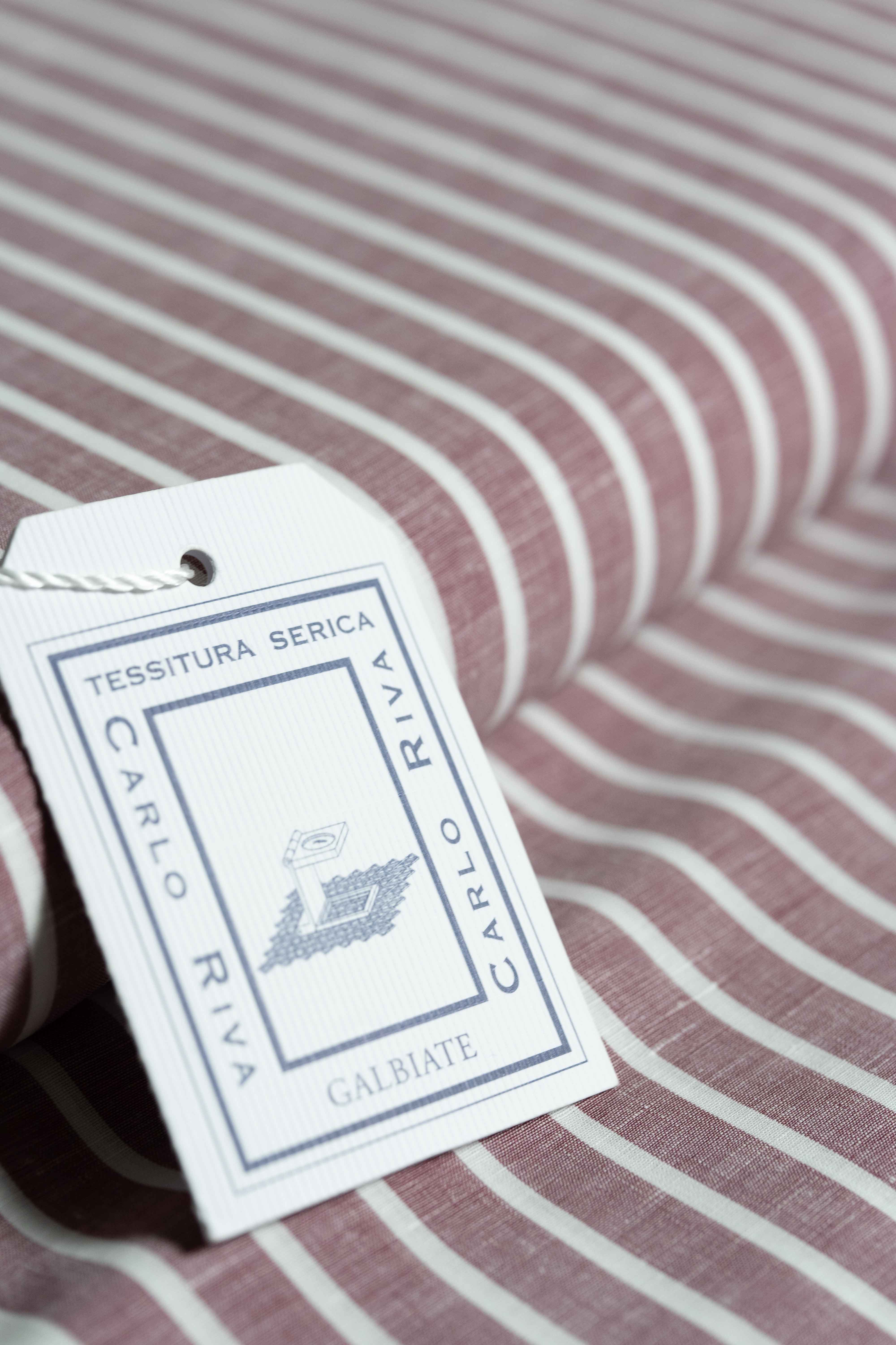 Carlo Riva red stripe fabric with label, showcasing high-quality textile and design features.