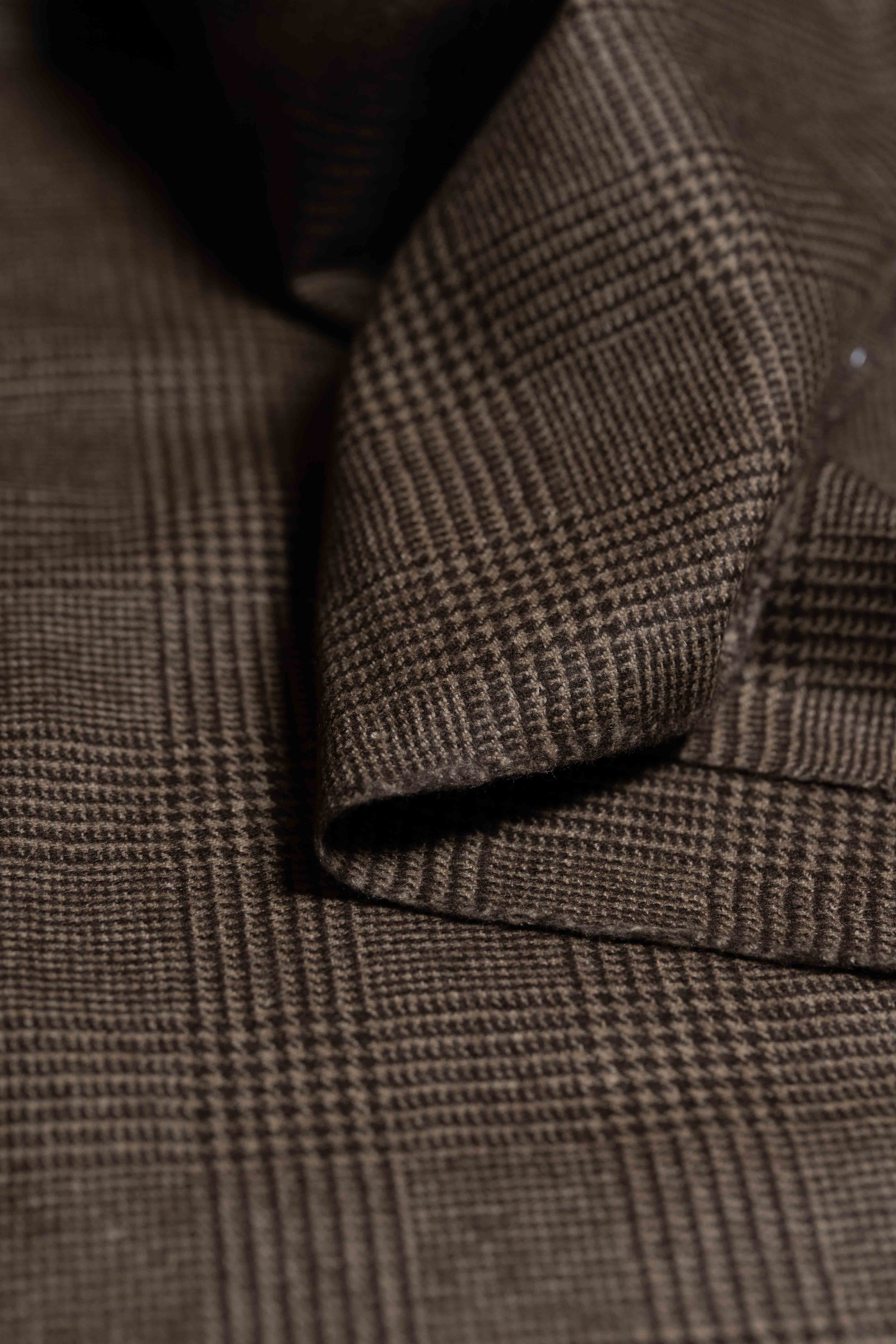 Joshua Ellis Brown Glen Plaid Pure Cashmere fabric close-up, showing texture and pattern in rich brown tones.