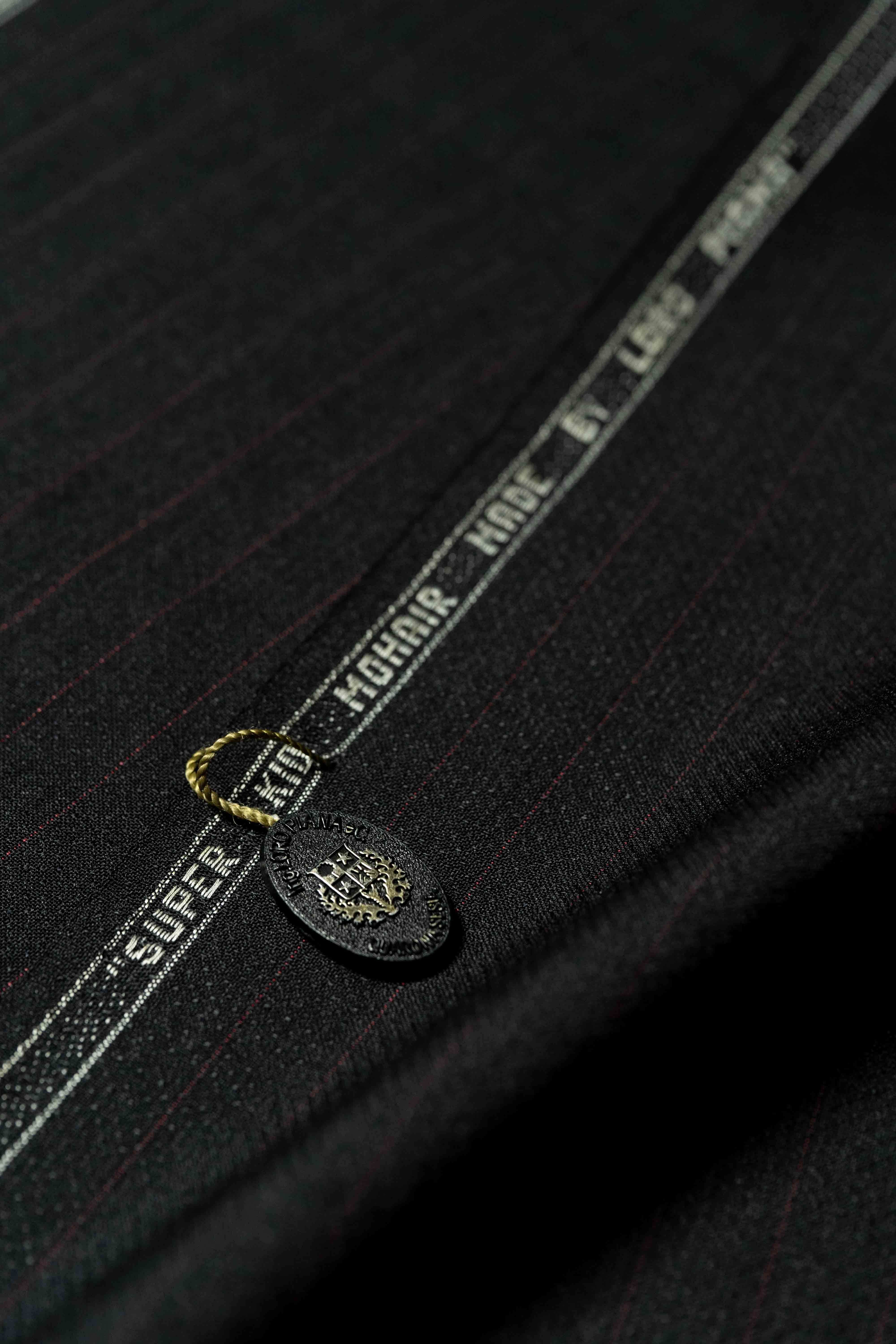 Loro Piana Black & Red Stripe Kid Mohair Suiting fabric showing detail and tags.